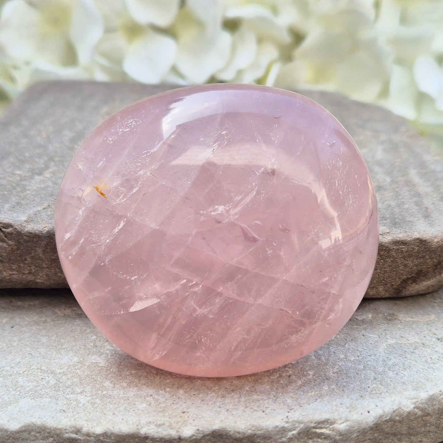Large polished Rose Quartz palm stone with soft pink colouring and a smooth, rounded shape designed to sit naturally and comfortably in the hand.