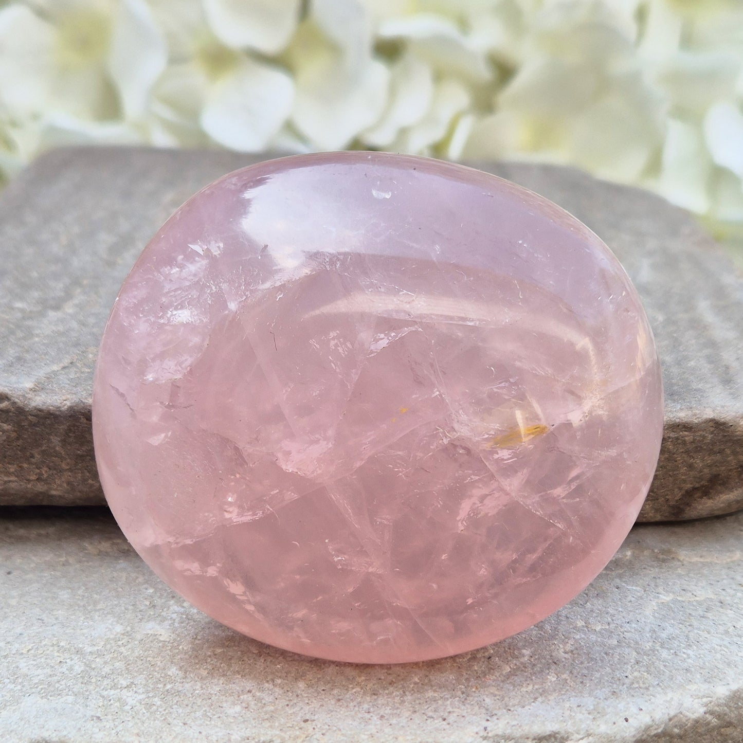 Large polished Rose Quartz palm stone with soft pink colouring and a smooth, rounded shape designed to sit naturally and comfortably in the hand.