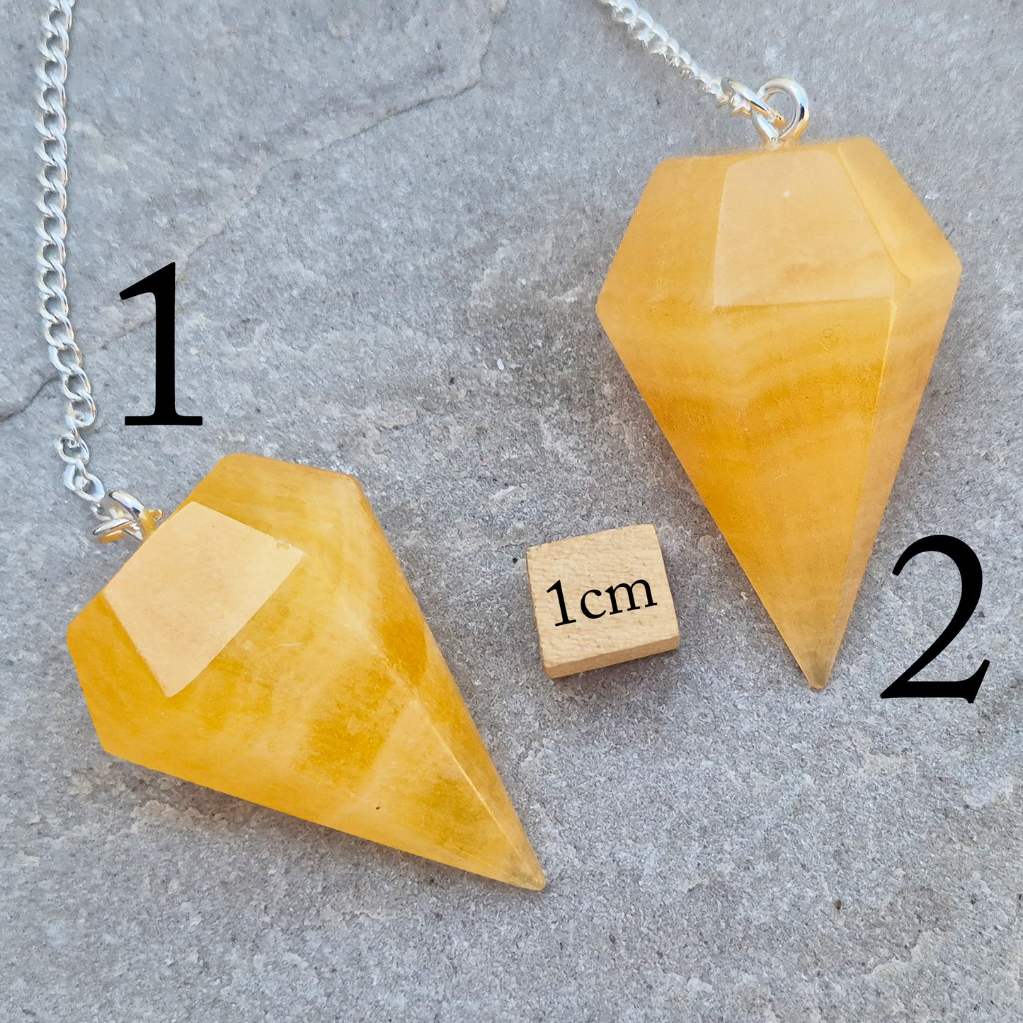 Polished Orange Calcite crystal pendulum on a silver colour chain, perfect for dowsing, decision-making, crystal healing, boosting creativity and energy work.