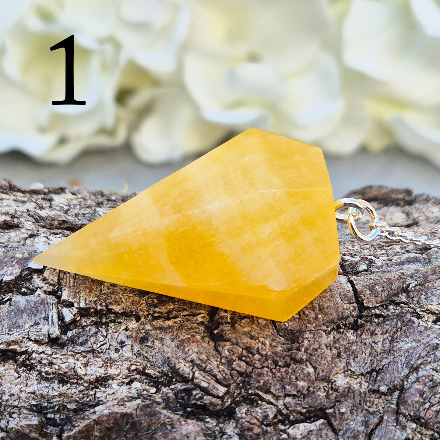 Polished Orange Calcite crystal pendulum on a silver colour chain, perfect for dowsing, decision-making, crystal healing, boosting creativity and energy work.
