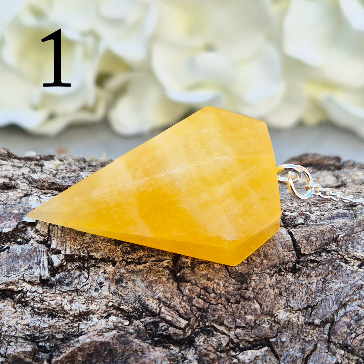 Polished Orange Calcite crystal pendulum on a silver colour chain, perfect for dowsing, decision-making, crystal healing, boosting creativity and energy work.
