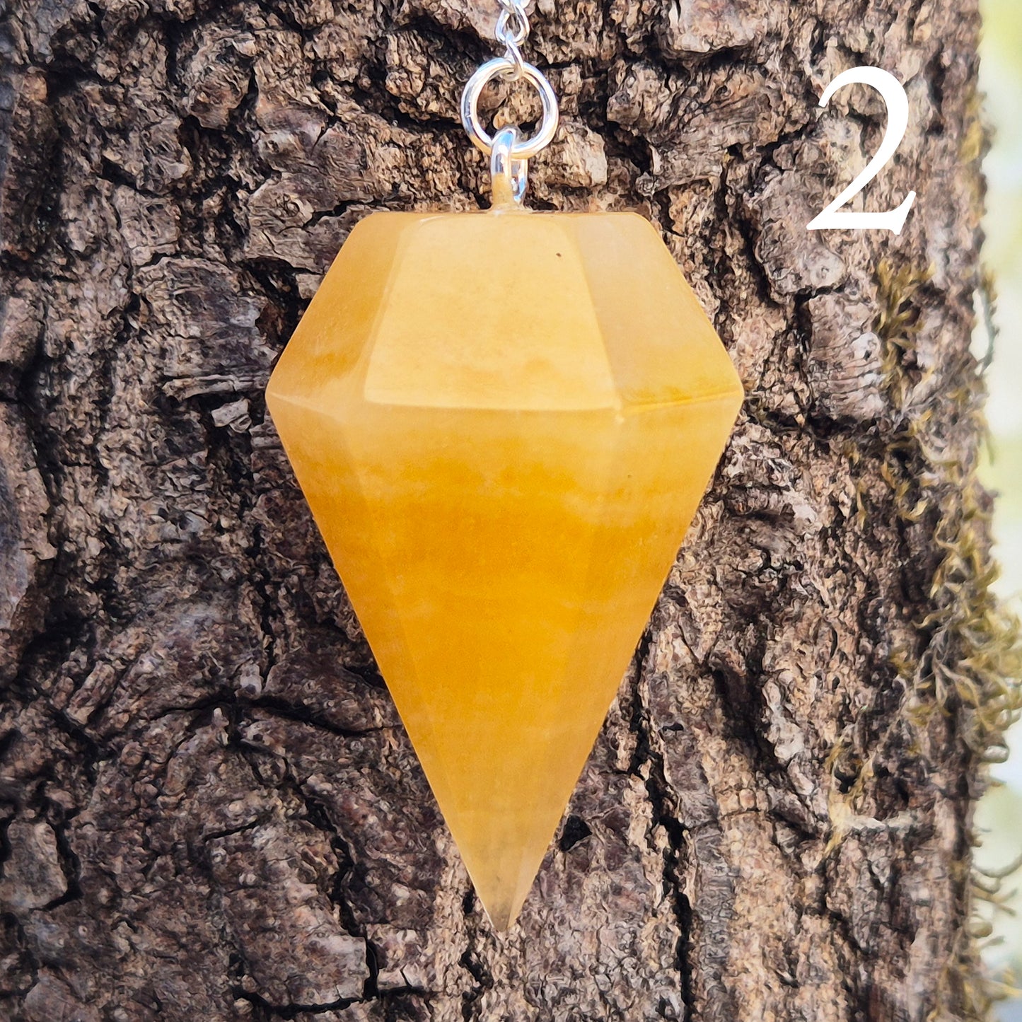 Polished Orange Calcite crystal pendulum on a silver colour chain, perfect for dowsing, decision-making, crystal healing, boosting creativity and energy work.