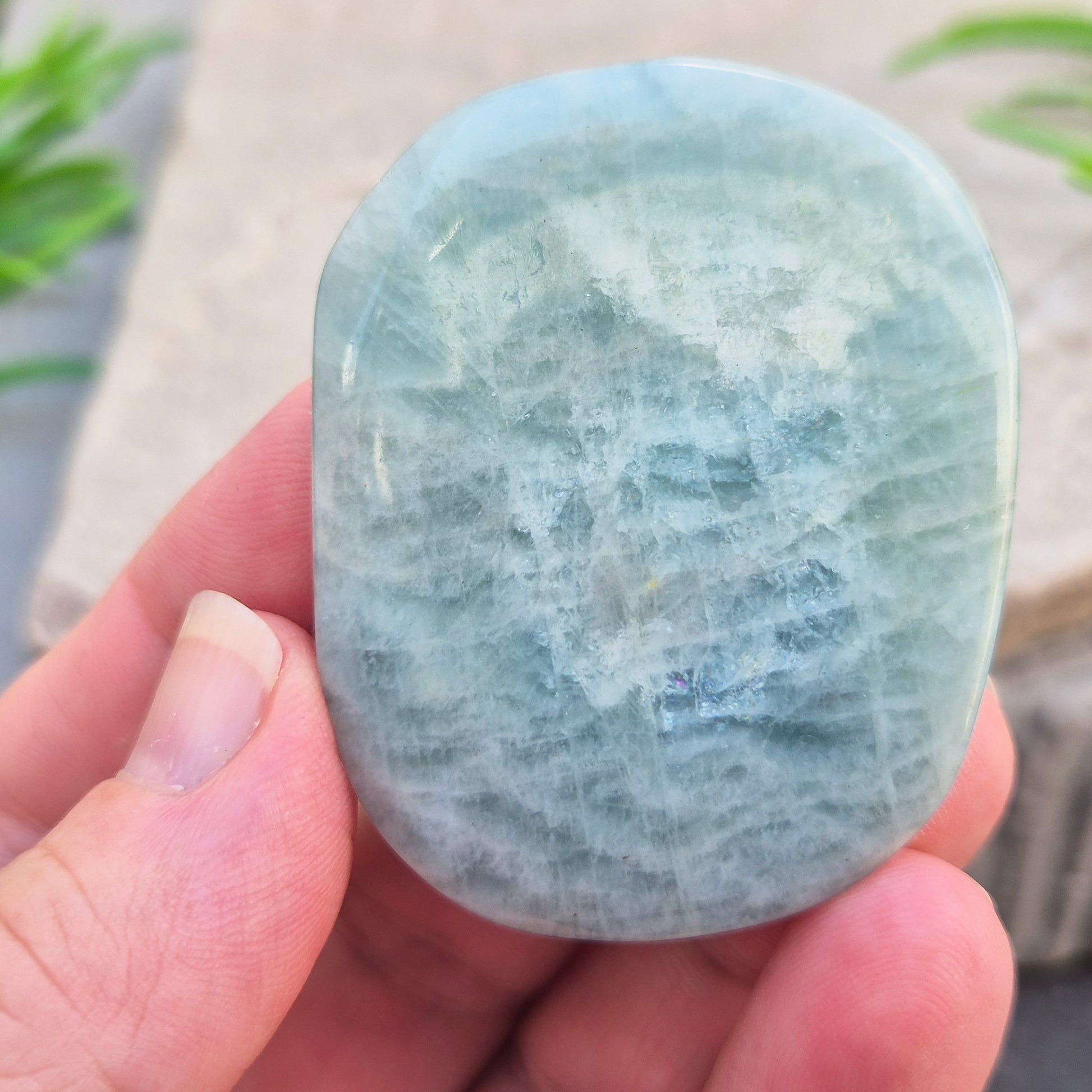 polished Aquamarine palm stone — calming, aqua blue crystal known for supporting clear communication. A thoughtful gift for anyone facing a stressful time.