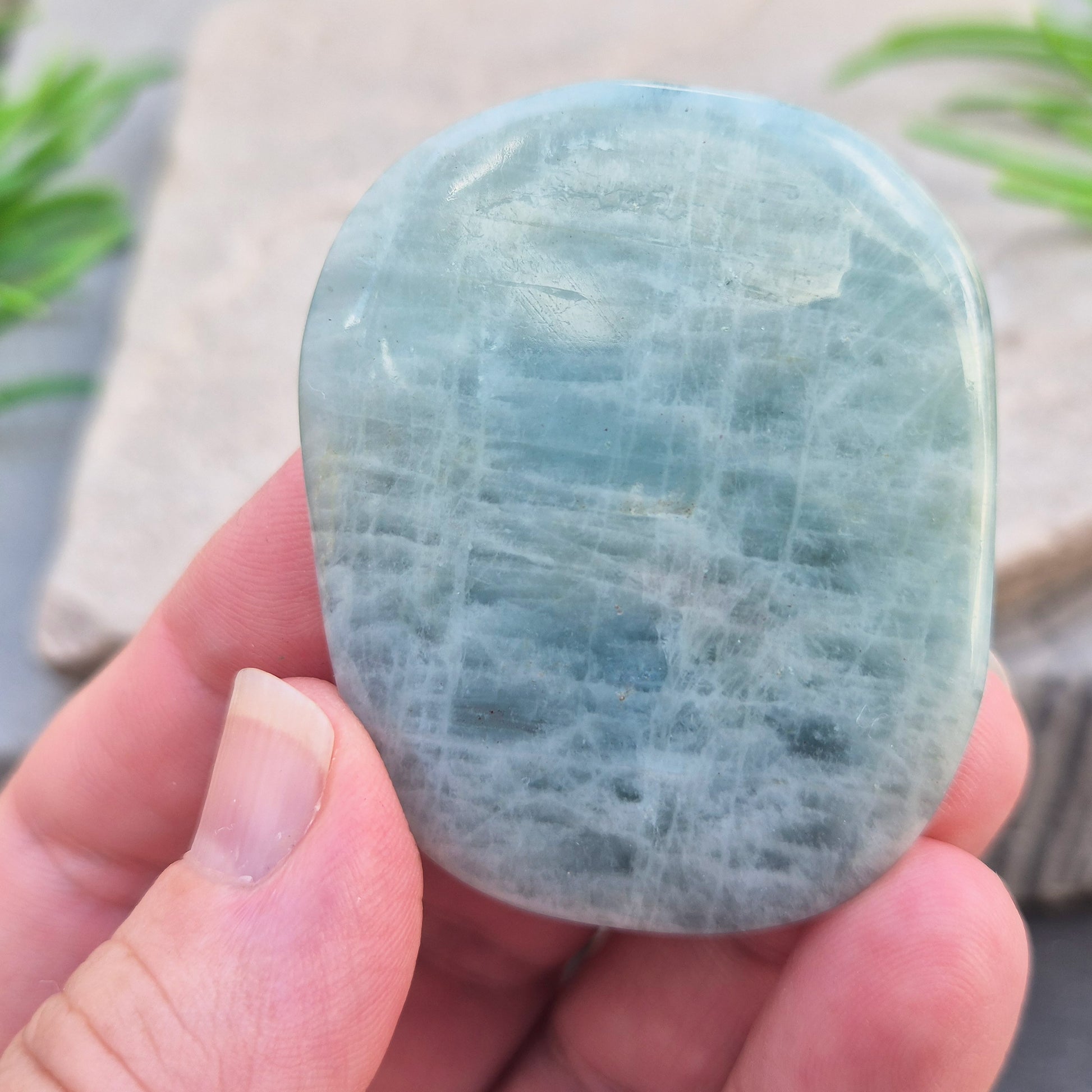 polished Aquamarine palm stone — calming, aqua blue crystal known for supporting clear communication. A thoughtful gift for anyone facing a stressful time.