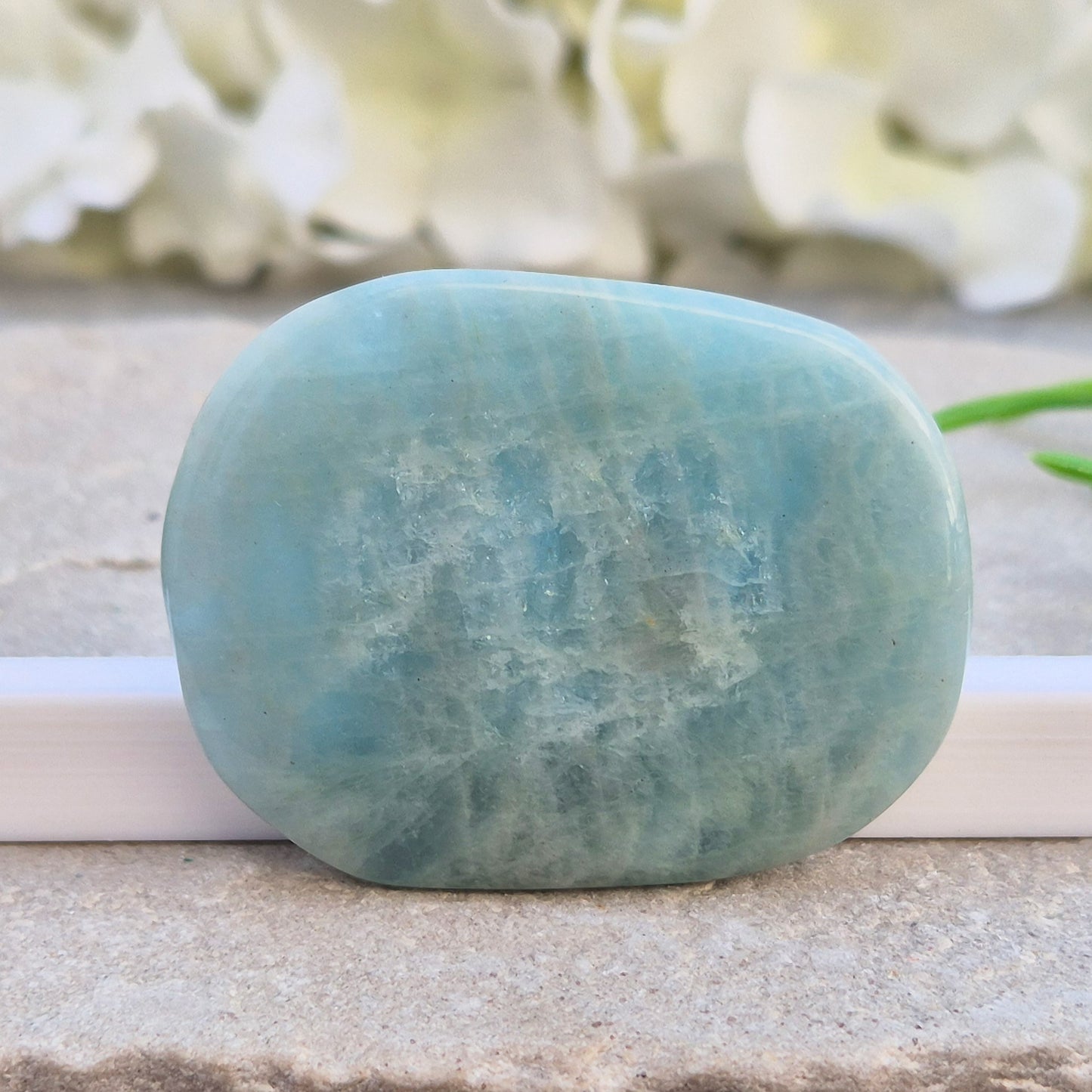 polished Aquamarine palm stone — calming, aqua blue crystal known for supporting clear communication. A thoughtful gift for anyone facing a stressful time.