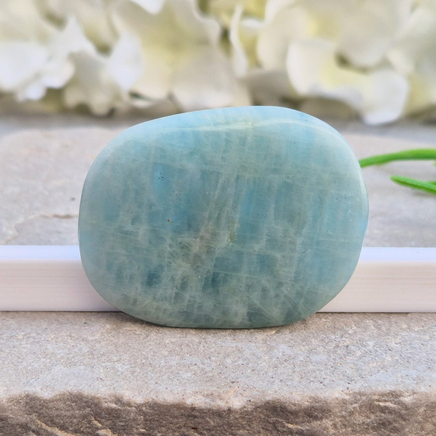 polished Aquamarine palm stone — calming, aqua blue crystal known for supporting clear communication. A thoughtful gift for anyone facing a stressful time.