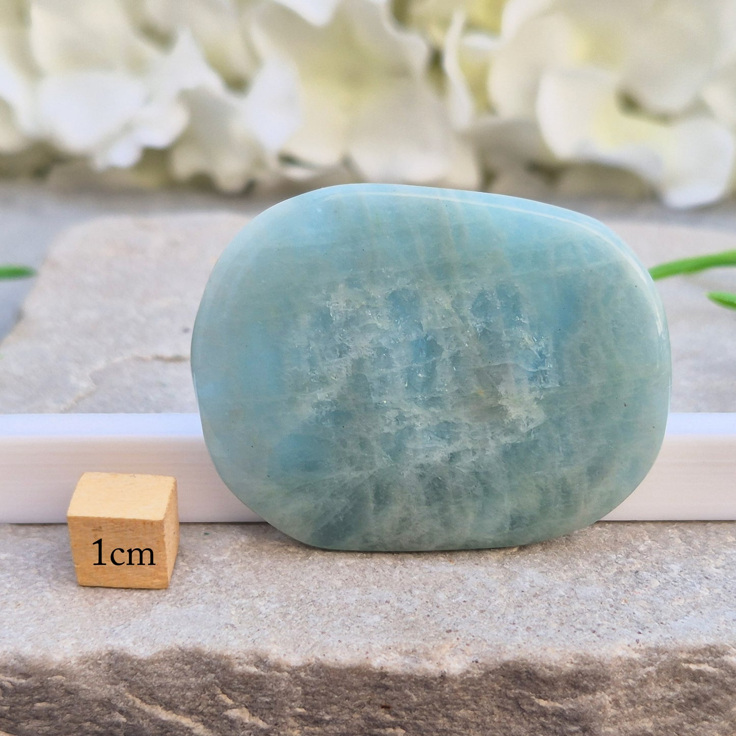 polished Aquamarine palm stone — calming, aqua blue crystal known for supporting clear communication. A thoughtful gift for anyone facing a stressful time.