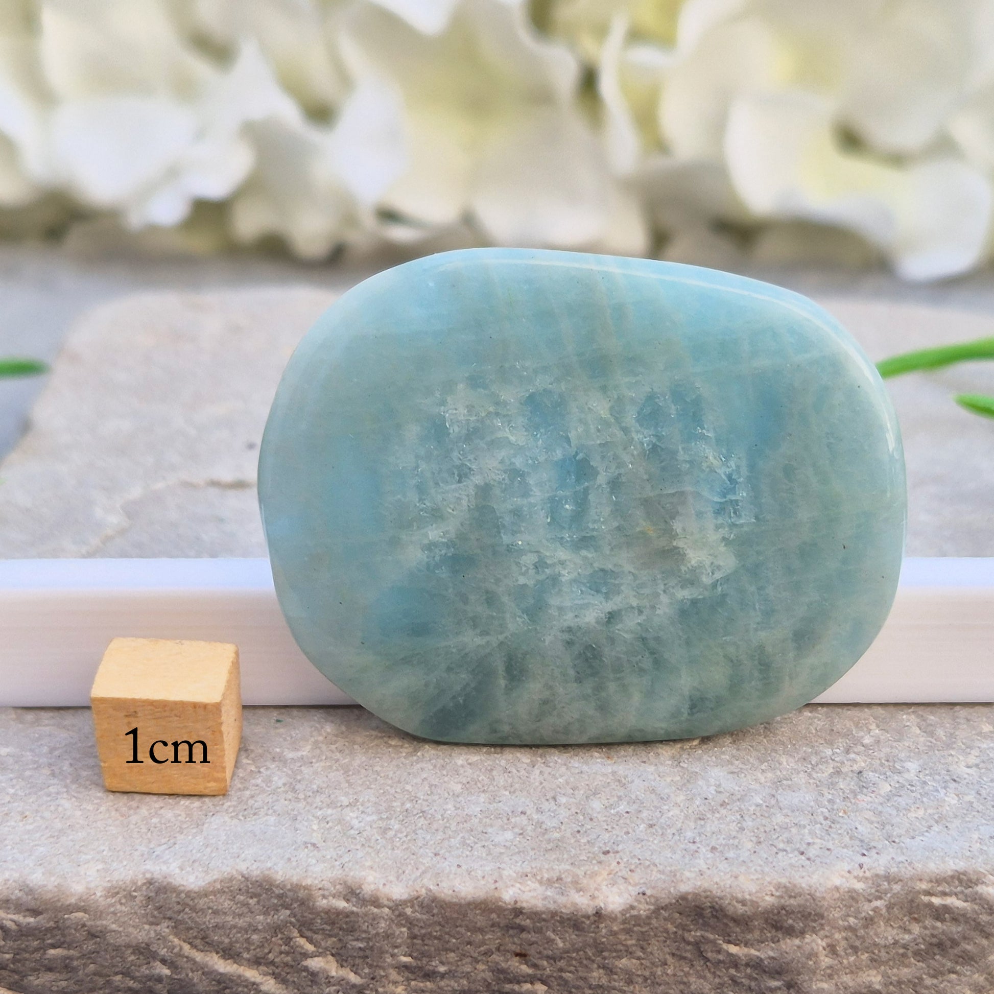 polished Aquamarine palm stone — calming, aqua blue crystal known for supporting clear communication. A thoughtful gift for anyone facing a stressful time.