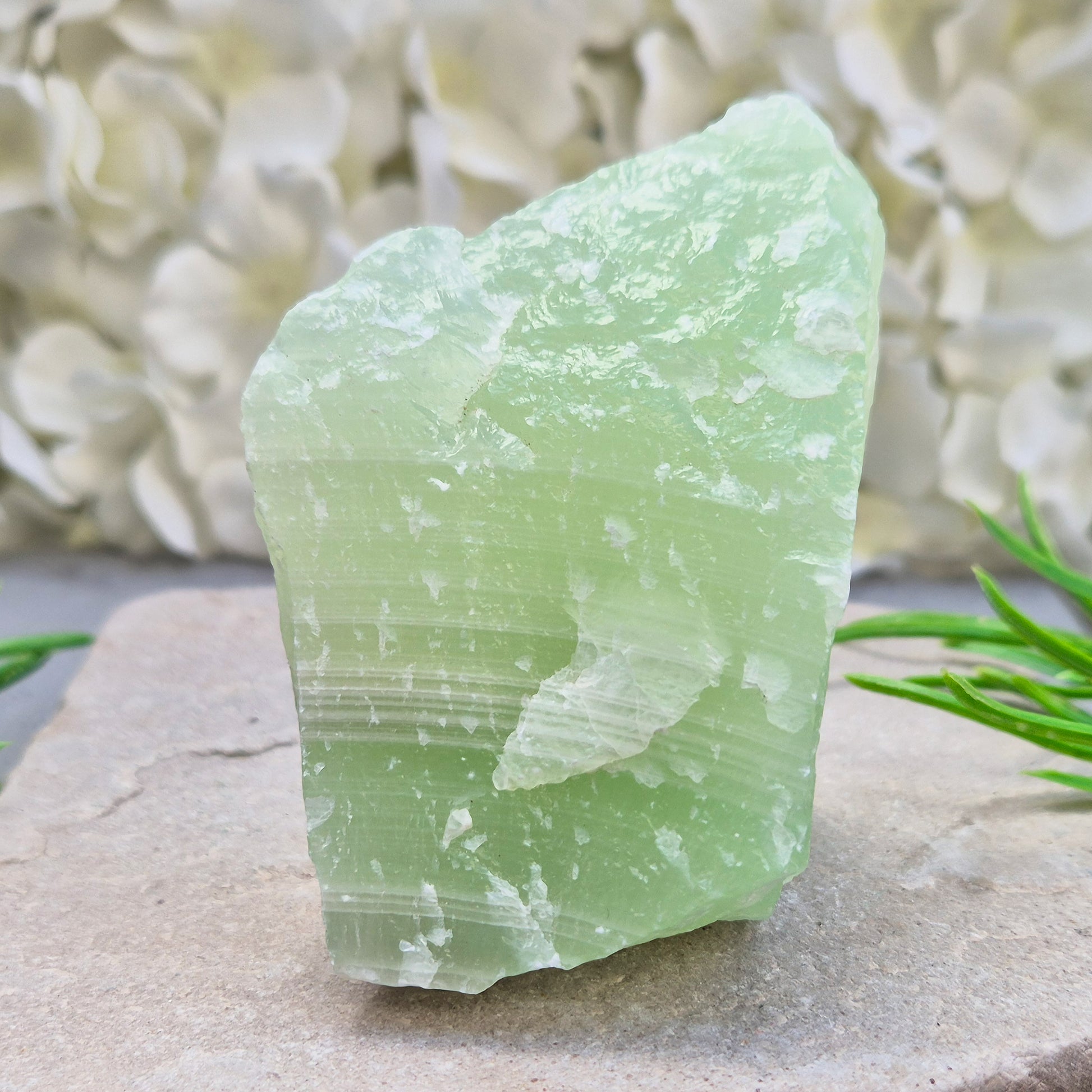 This natural self-standing Pistachio Calcite crystal comes from Pakistan and shows soft pale green to pistachio tones. This variety of Green Calcite gets its colouring from trace minerals embedded as the calcite formed.