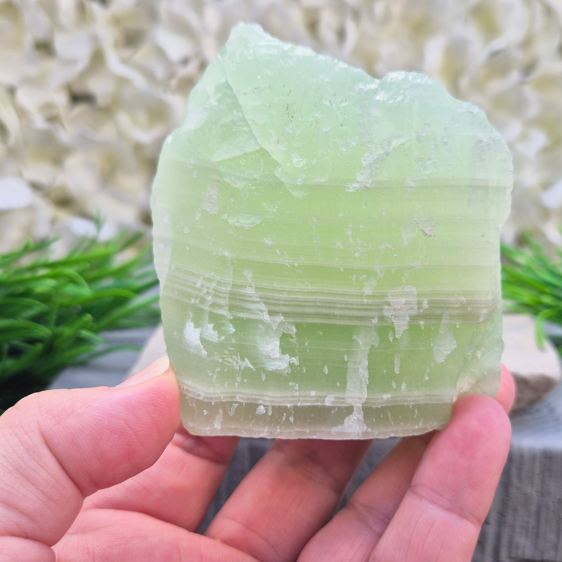 This natural self-standing Pistachio Calcite crystal comes from Pakistan and shows soft pale green to pistachio tones. This variety of Green Calcite gets its colouring from trace minerals embedded as the calcite formed.