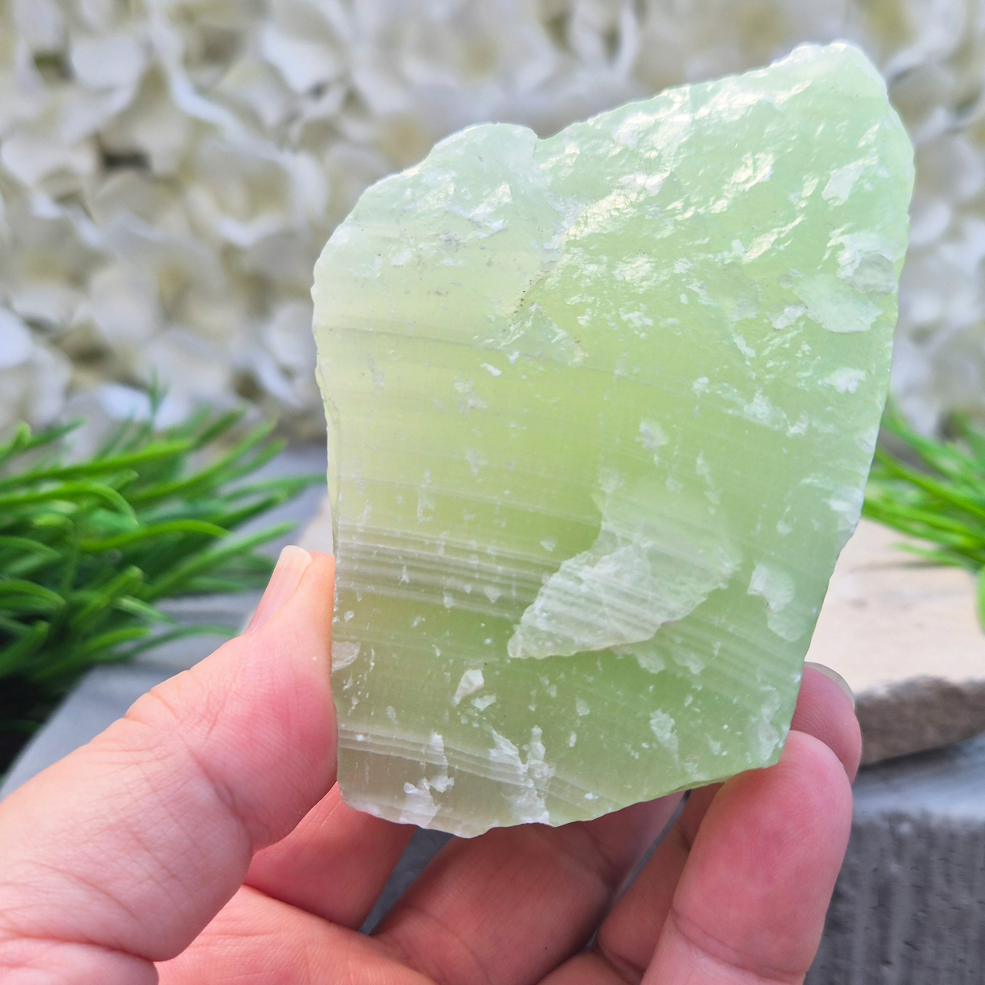 This natural self-standing Pistachio Calcite crystal comes from Pakistan and shows soft pale green to pistachio tones. This variety of Green Calcite gets its colouring from trace minerals embedded as the calcite formed.