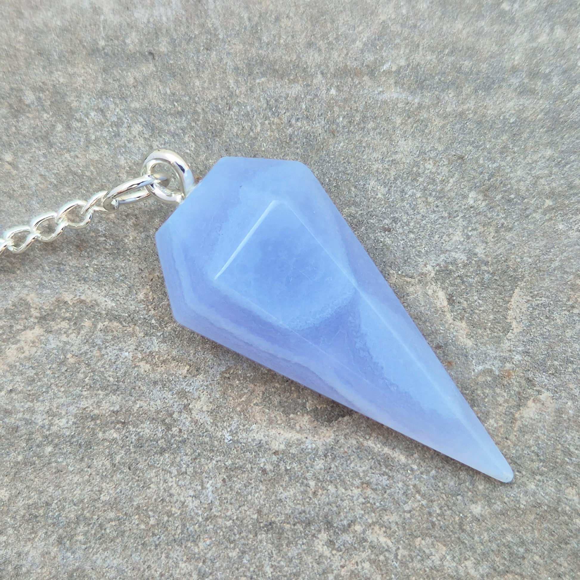 Blue Lace Agate crystal pendulum, known for its calming energy. Ideal for dowsing, spiritual guidance, and bringing a steady, peaceful feel.