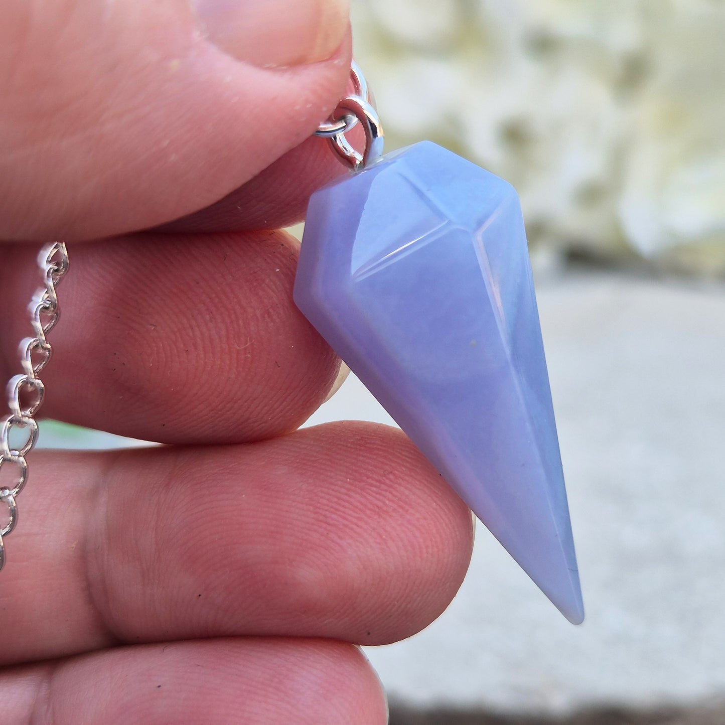 Blue Lace Agate crystal pendulum, known for its calming energy. Ideal for dowsing, spiritual guidance, and bringing a steady, peaceful feel.