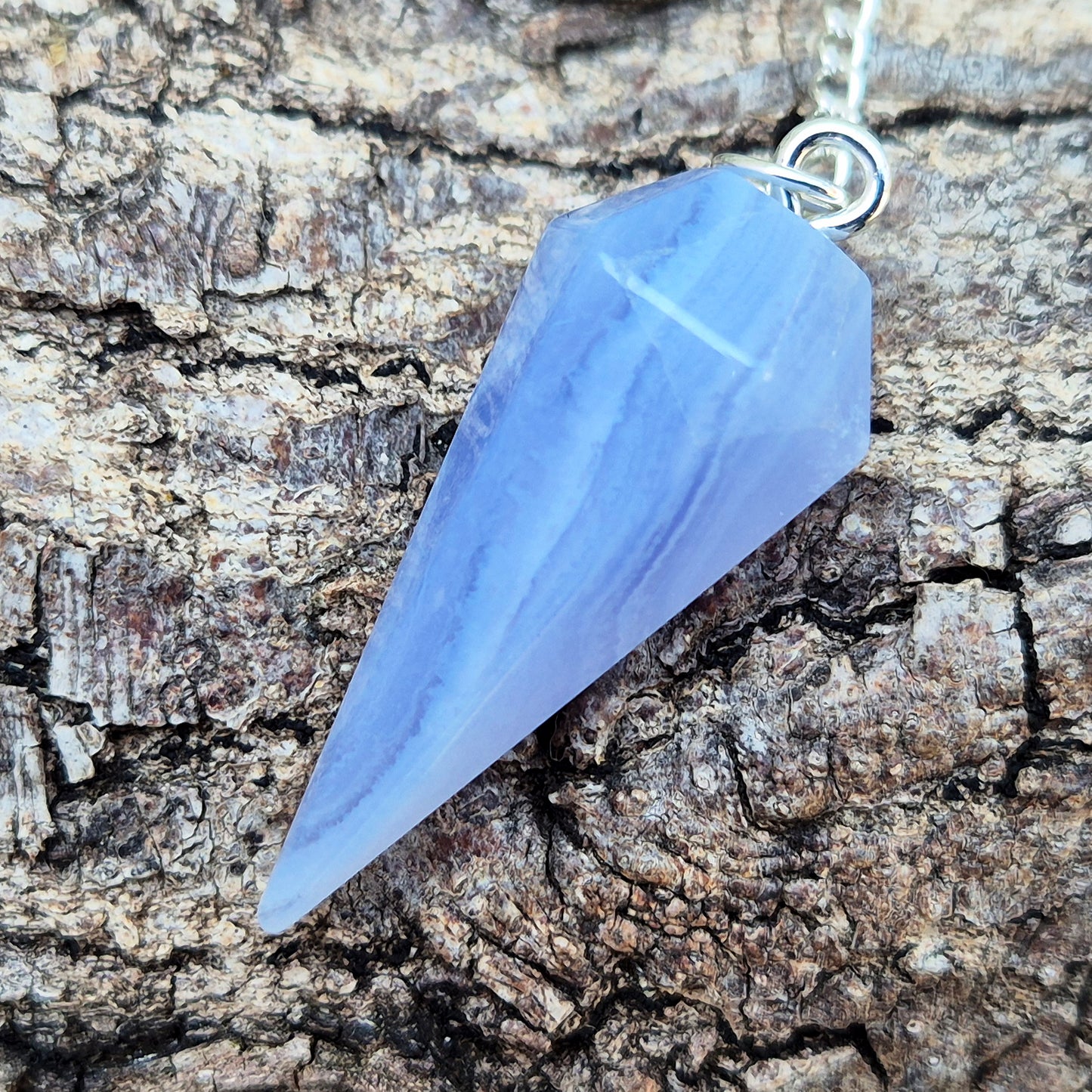 Blue Lace Agate crystal pendulum, known for its calming energy. Ideal for dowsing, spiritual guidance, and bringing a steady, peaceful feel.
