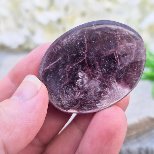 Metallic lilac Mica palm stone. Smooth, reflective, and grounding. Supports focus, calm emotions, and adds uplifting energy to any space.