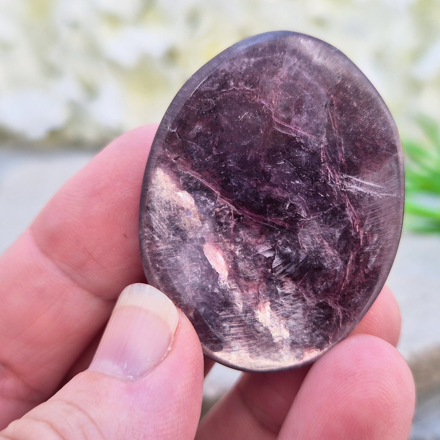 Metallic lilac Mica palm stone. Smooth, reflective, and grounding. Supports focus, calm emotions, and adds uplifting energy to any space.