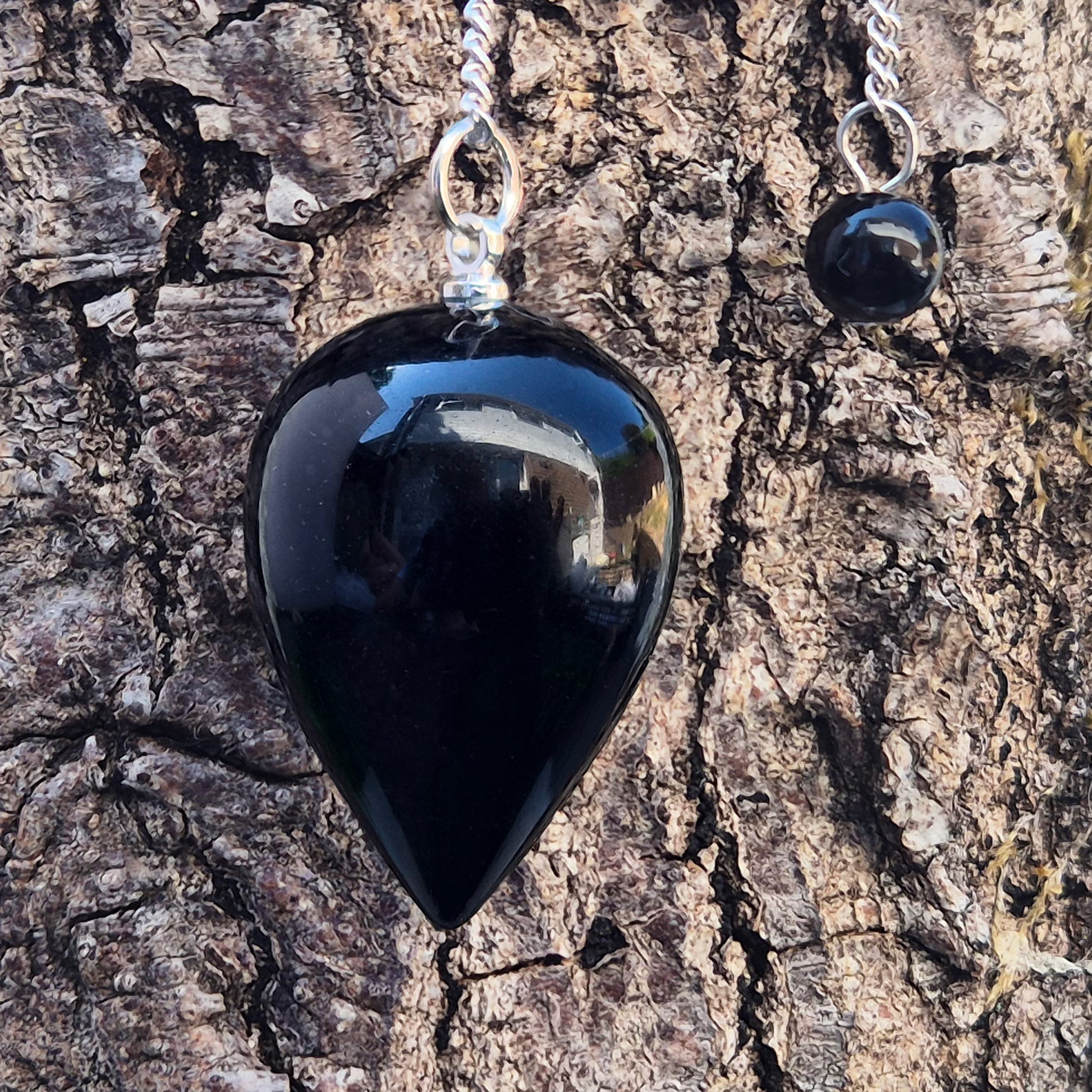 Black Obsidian teardrop pendulum for dowsing & energy work. Grounding and protective, this natural crystal helps clear negativity and ground your energy.