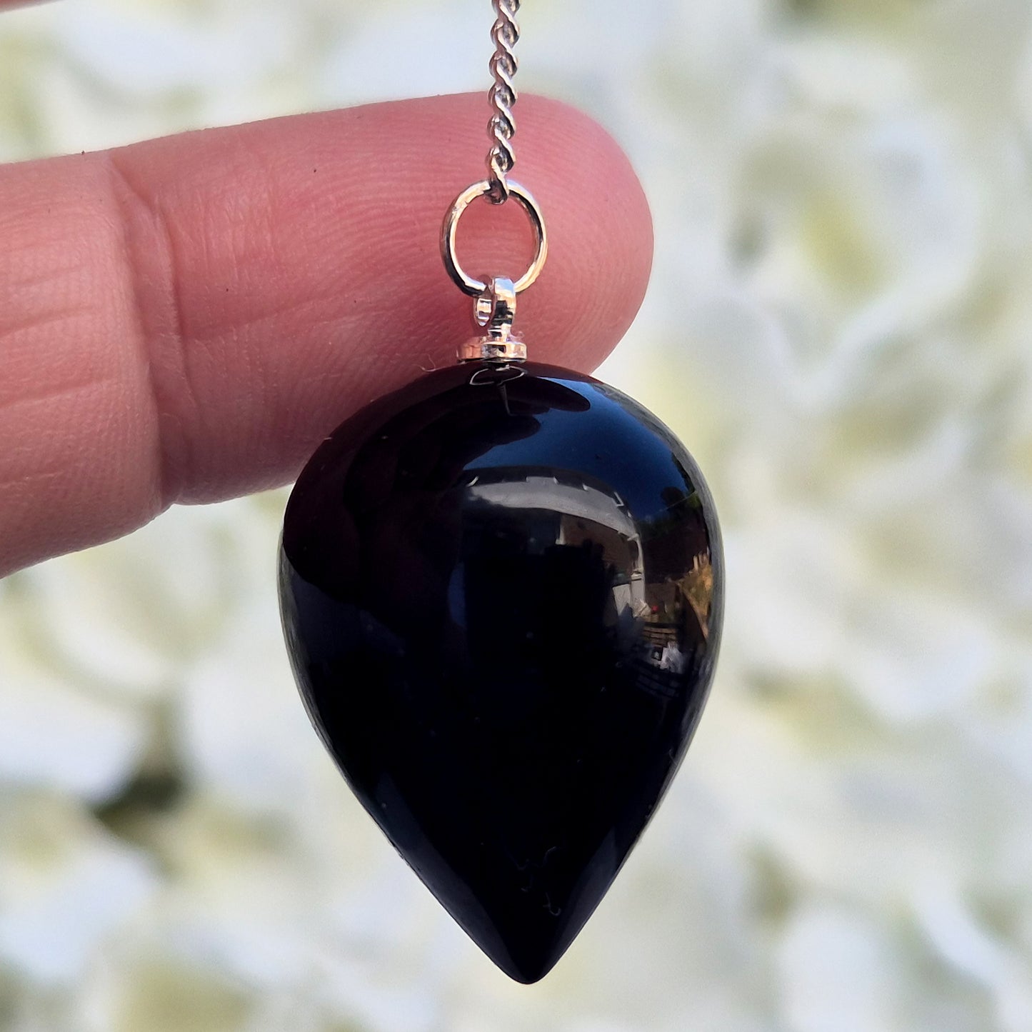 Black Obsidian teardrop pendulum for dowsing & energy work. Grounding and protective, this natural crystal helps clear negativity and ground your energy.
