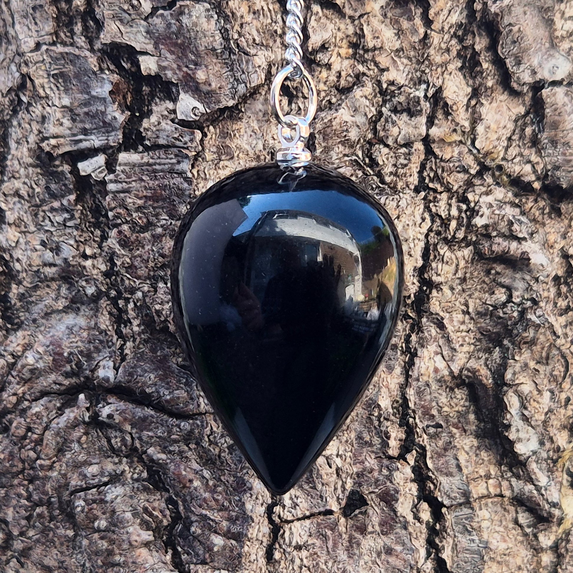 Black Obsidian teardrop pendulum for dowsing & energy work. Grounding and protective, this natural crystal helps clear negativity and ground your energy.