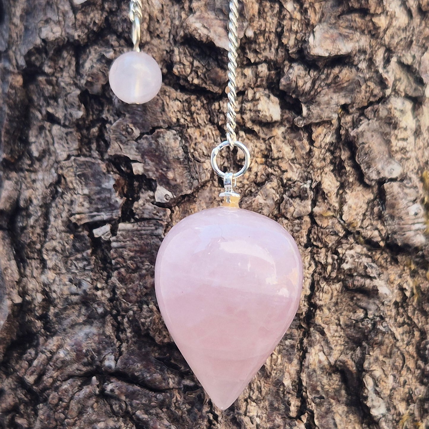 Rose Quartz Crystal Pendulum with a tear drop shape and its has a pale pink bead at the end of the chain. It will come with an organza pouch for safe keeping.