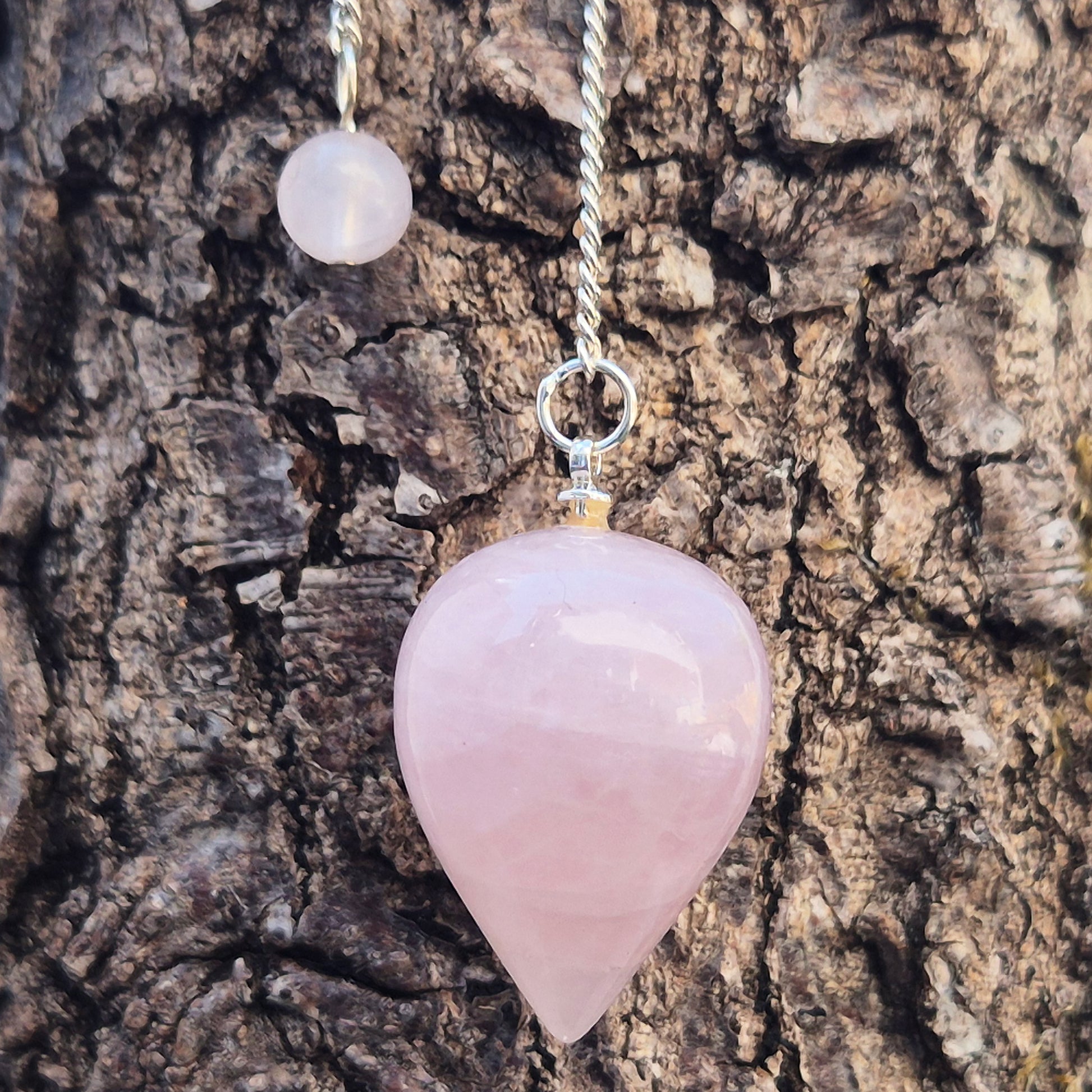 Rose Quartz Crystal Pendulum with a tear drop shape and its has a pale pink bead at the end of the chain. It will come with an organza pouch for safe keeping.