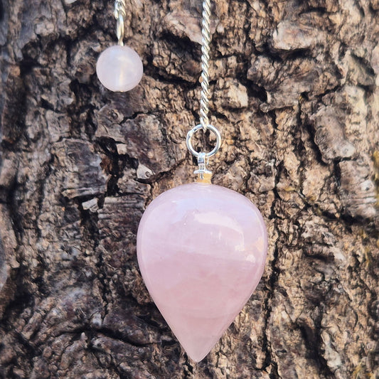 Rose Quartz Crystal Pendulum with a tear drop shape and its has a pale pink bead at the end of the chain. It will come with an organza pouch for safe keeping.