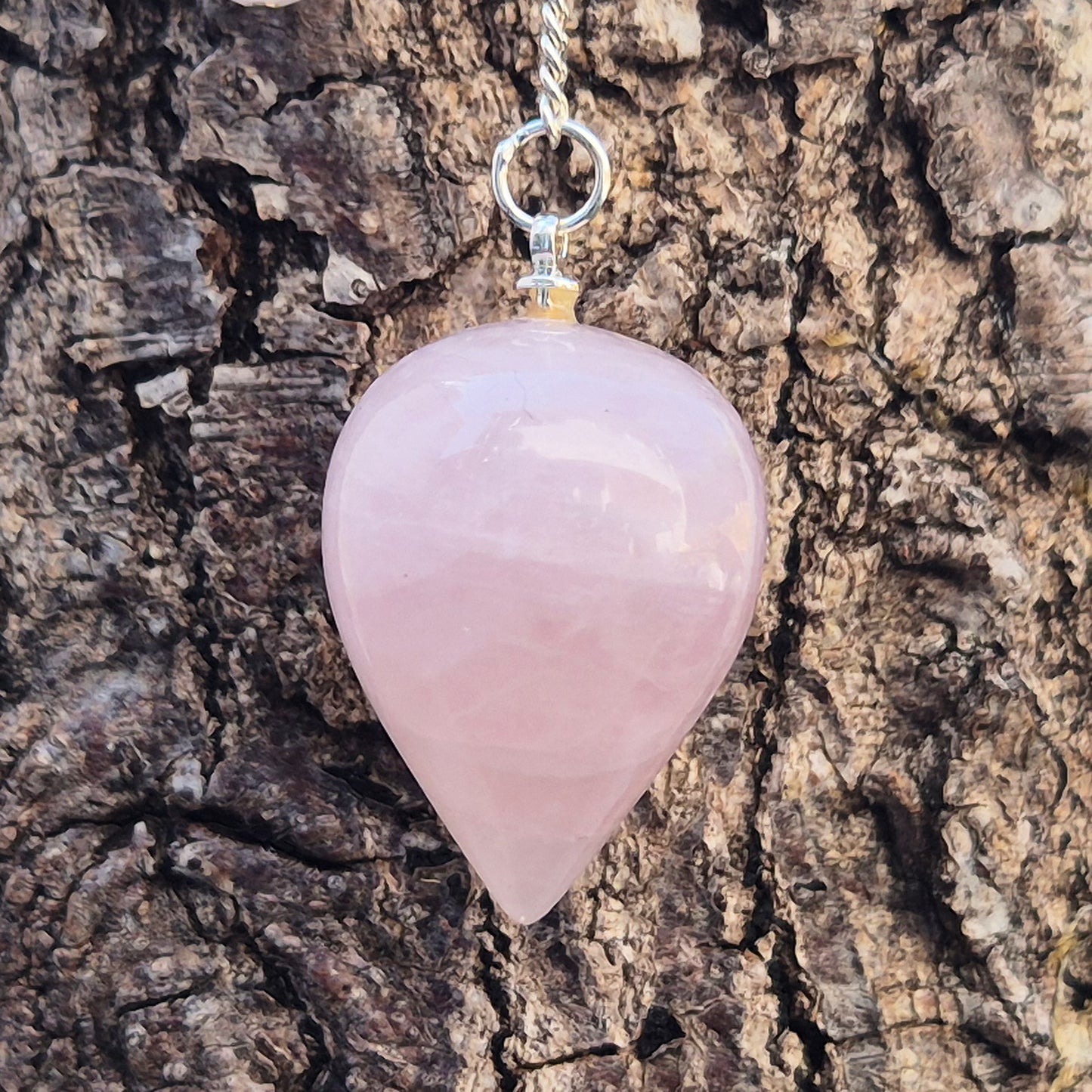 Rose Quartz Crystal Pendulum with a tear drop shape and its has a pale pink bead at the end of the chain. It will come with an organza pouch for safe keeping.