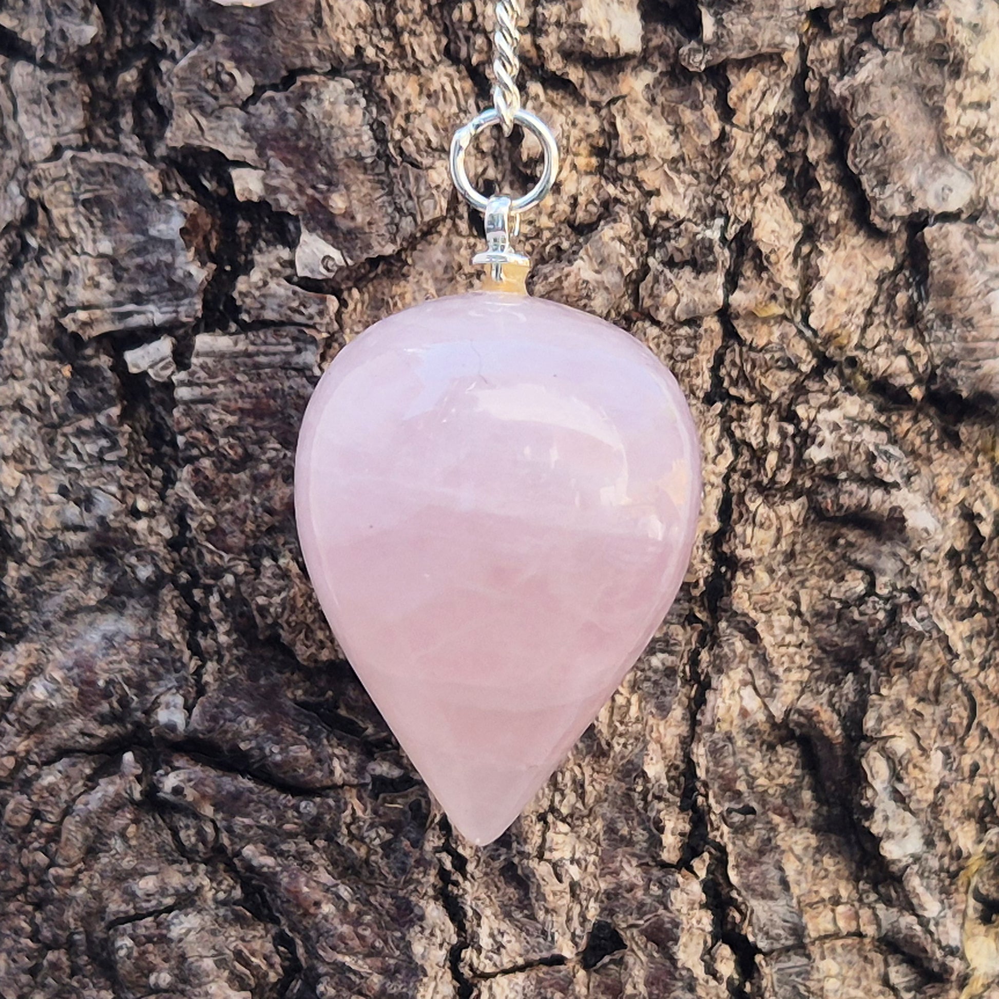 Rose Quartz Crystal Pendulum with a tear drop shape and its has a pale pink bead at the end of the chain. It will come with an organza pouch for safe keeping.