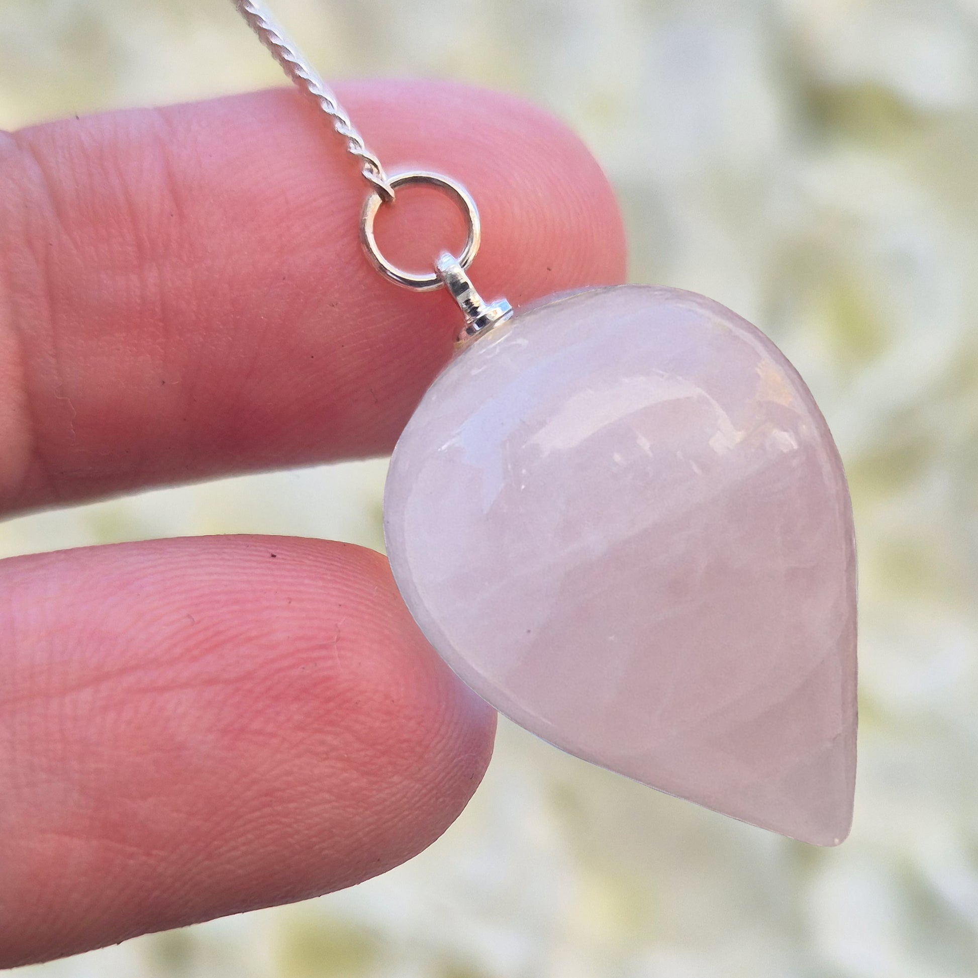Rose Quartz Crystal Pendulum with a tear drop shape and its has a pale pink bead at the end of the chain. It will come with an organza pouch for safe keeping.