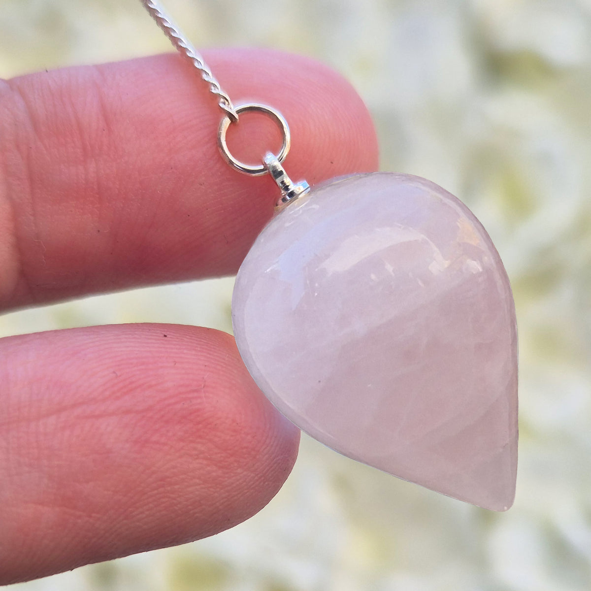 Rose Quartz Crystal Pendulum with a tear drop shape ideal to use for energy work, healing and during psychic work.