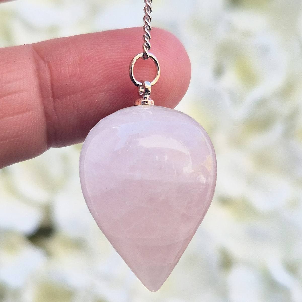 Rose Quartz Crystal Pendulum with a tear drop shape ideal to use for energy work, healing and during psychic work.