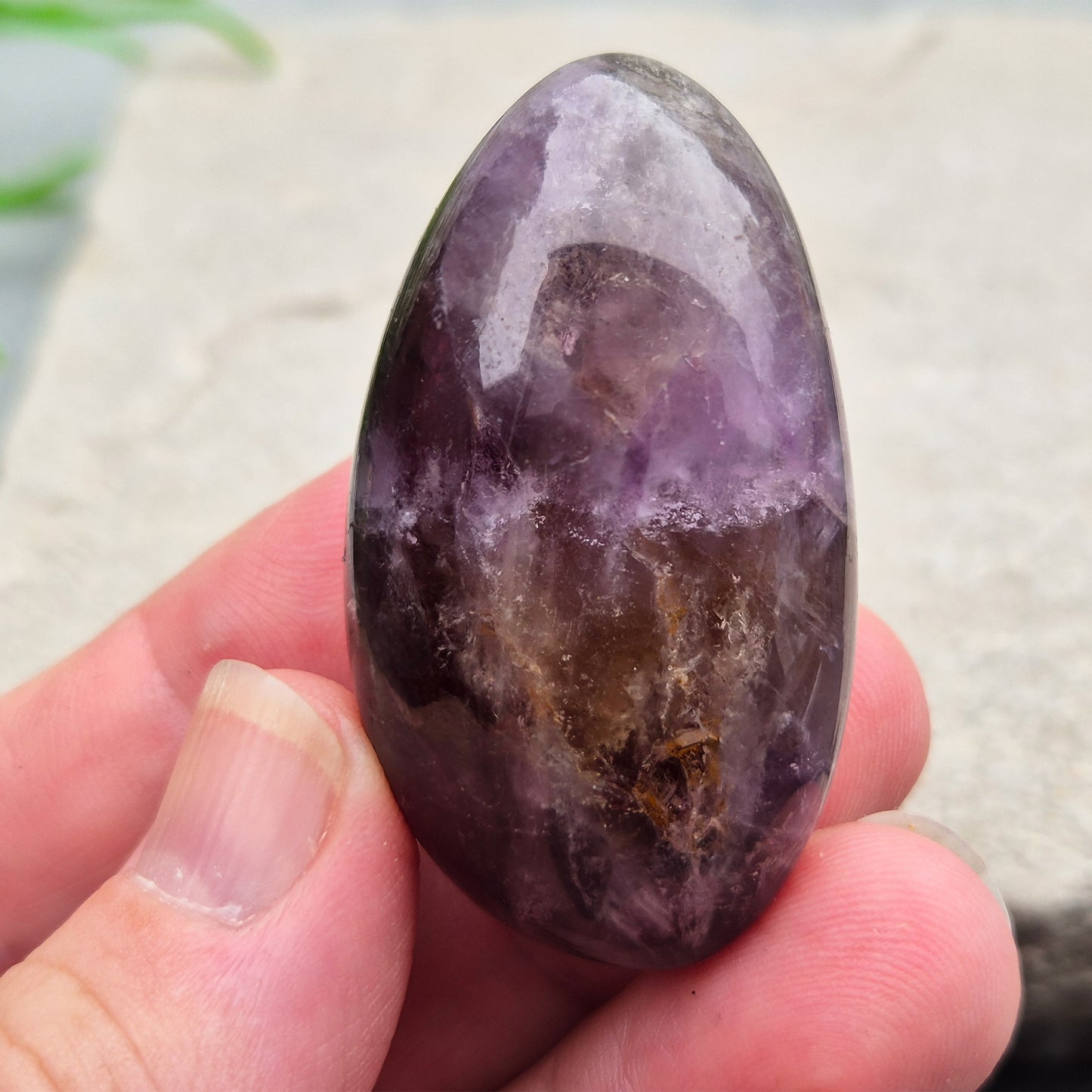 Ametrine polished palm stone with soft purple and golden tones. A natural blend of Amethyst and Citrine with a balanced, easy feel. 