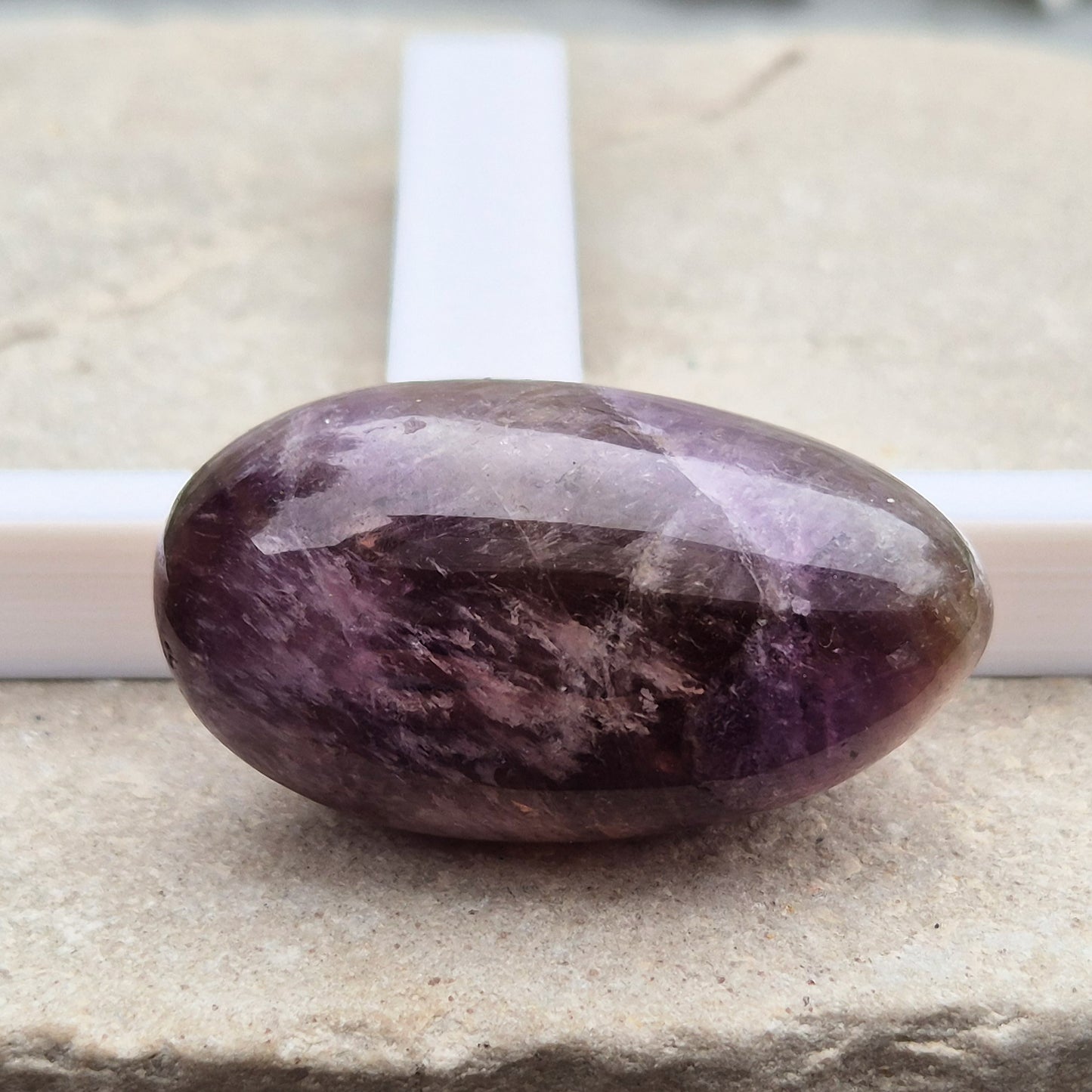 Ametrine polished palm stone with soft purple and golden tones. A natural blend of Amethyst and Citrine with a balanced, easy feel. 