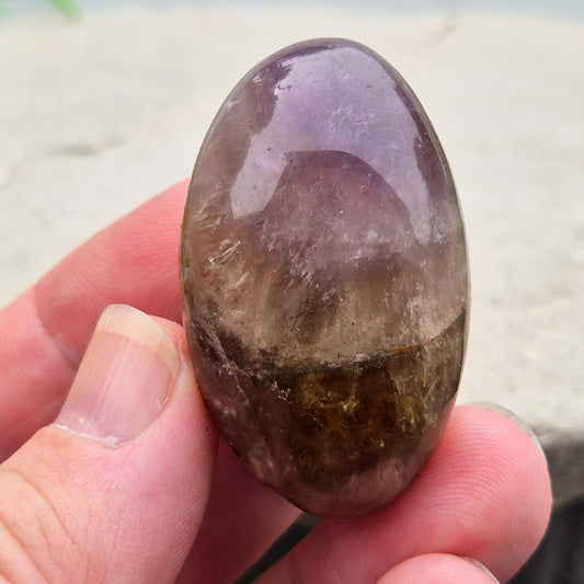 Ametrine polished palm stone with soft purple and golden tones. A natural blend of Amethyst and Citrine with a balanced, easy feel. 