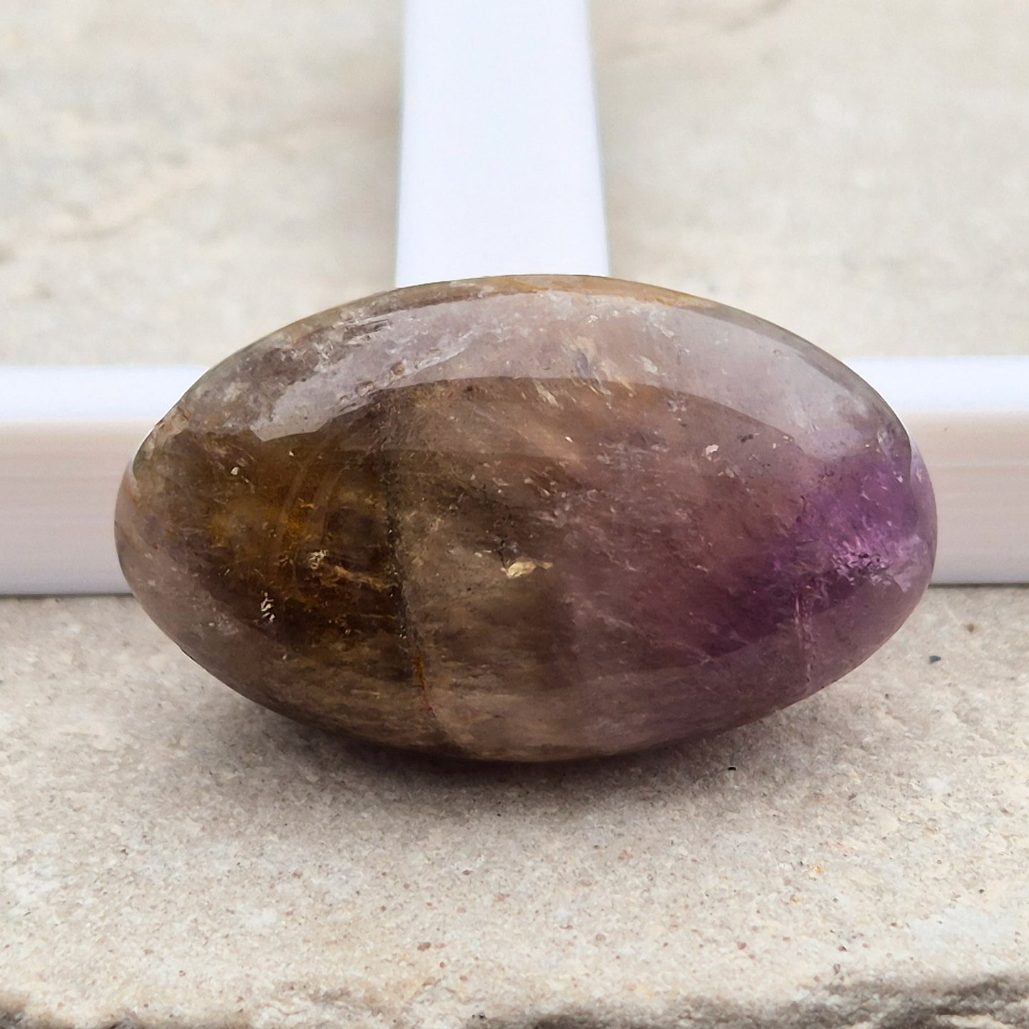 Ametrine polished palm stone with soft purple and golden tones. A natural blend of Amethyst and Citrine with a balanced, easy feel. 
