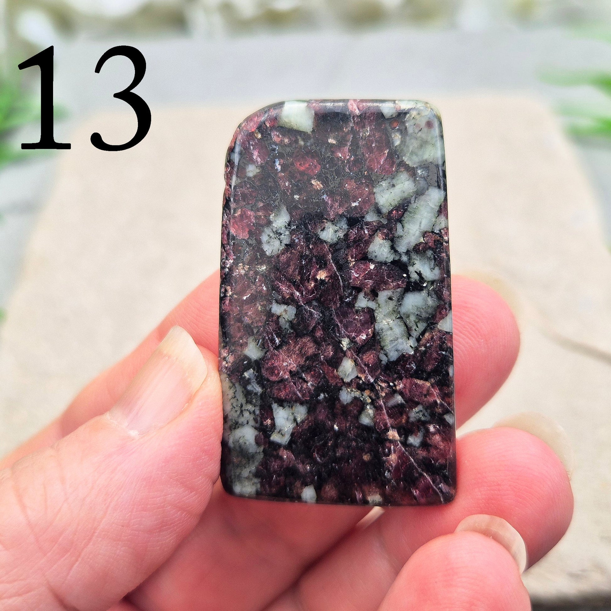 Polished Eudialyte flat stone from Greenland with rich red and pink tones. Associated with emotional steadiness, heart support, and grounded change.