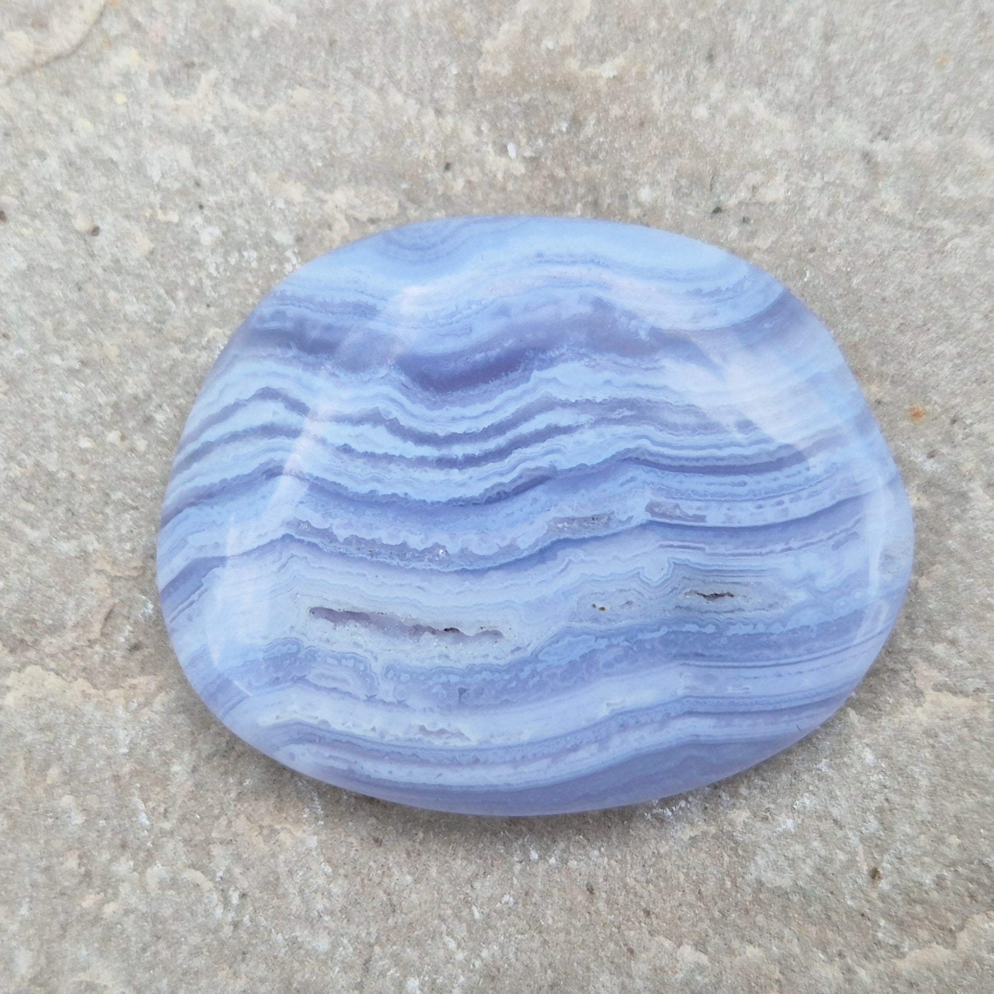 Polished Blue Lace Agate crystal palm stone with wonderful banding. A calming crystal, ideal for relaxation, clear communication and gentle healing.