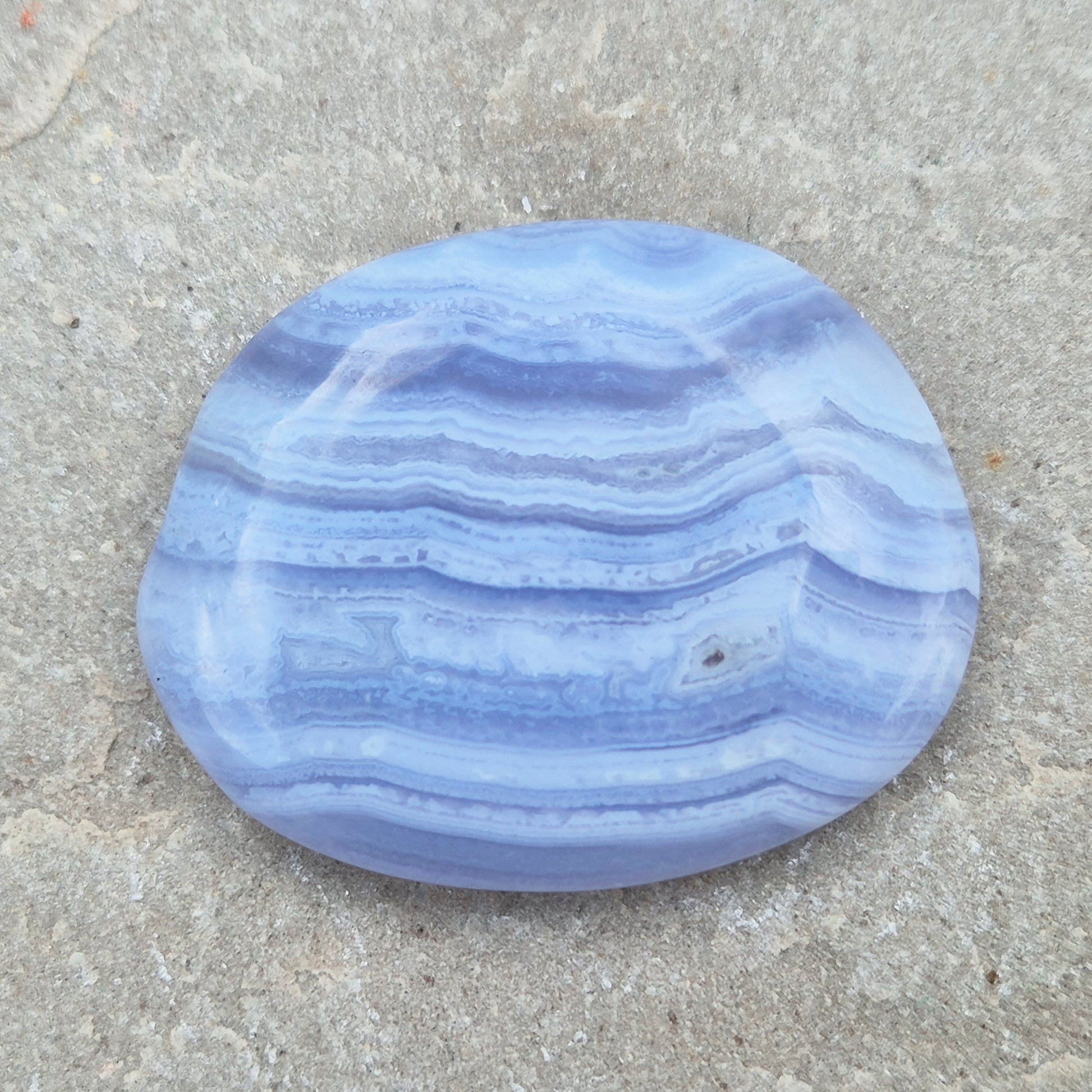 Polished Blue Lace Agate crystal palm stone with wonderful banding. A calming crystal, ideal for relaxation, clear communication and gentle healing.