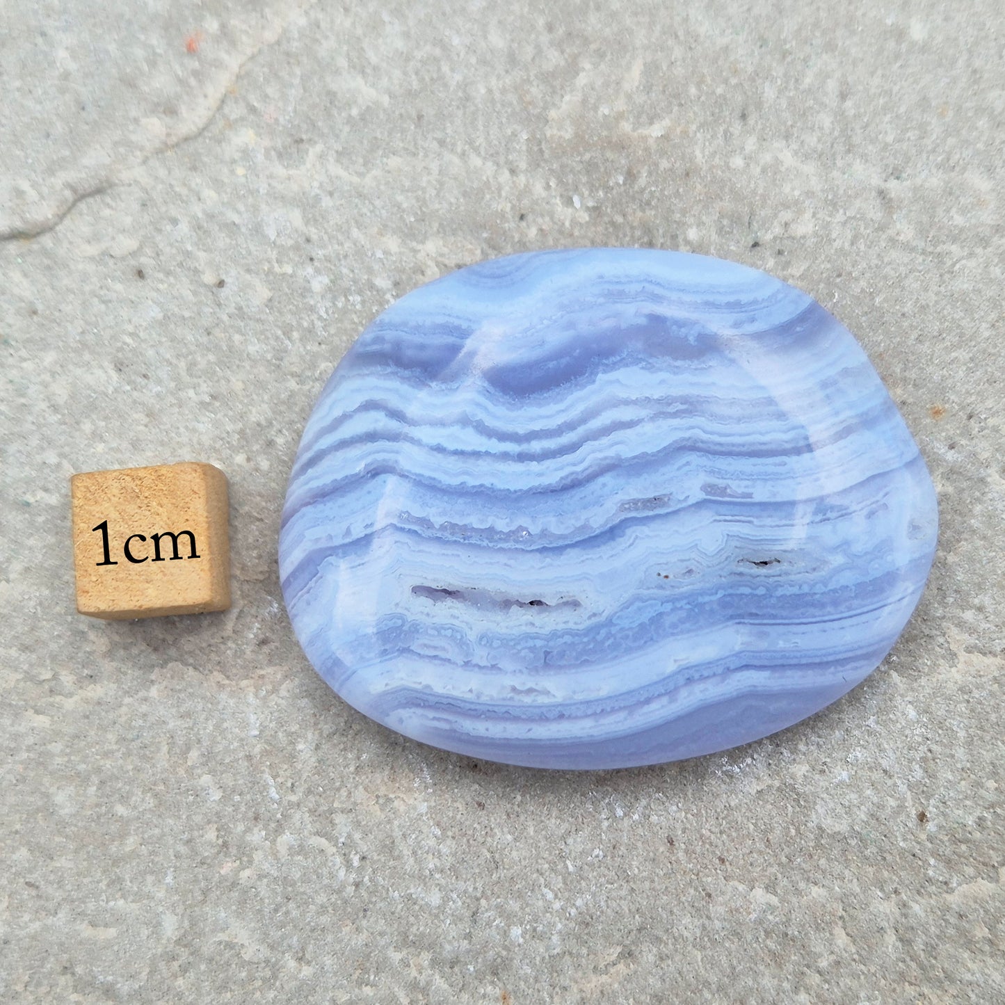 Polished Blue Lace Agate crystal palm stone with wonderful banding. A calming crystal, ideal for relaxation, clear communication and gentle healing.