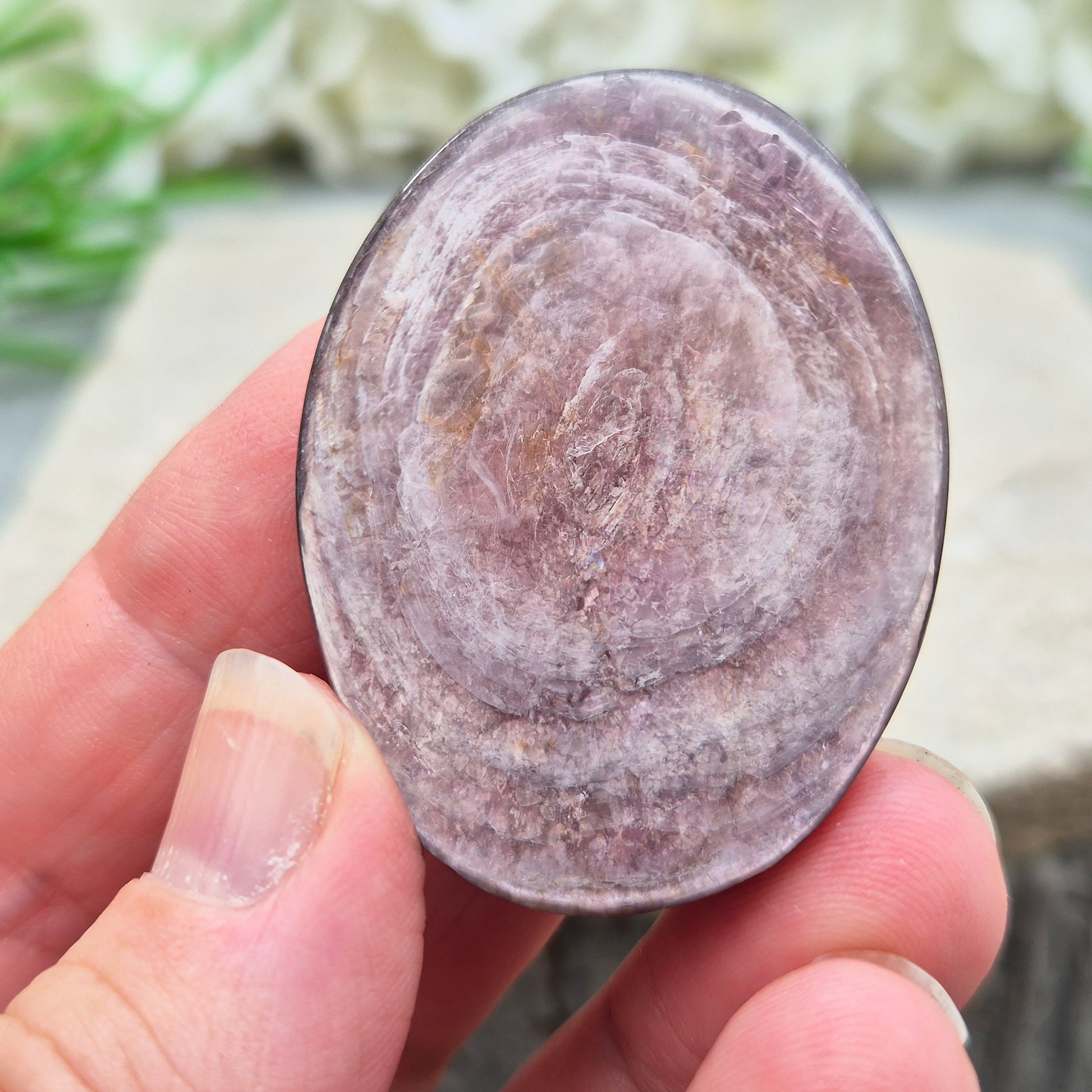 Mica palm stone in shimmering metallic lilac. Perfect for holding, mindful energy, and gifting. Helps steady thoughts, balance emotions, and uplift.