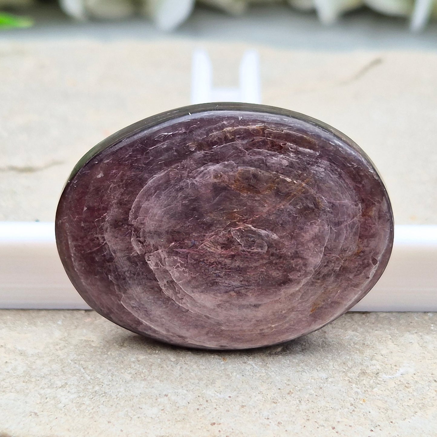 Mica palm stone in shimmering metallic lilac. Perfect for holding, mindful energy, and gifting. Helps steady thoughts, balance emotions, and uplift.