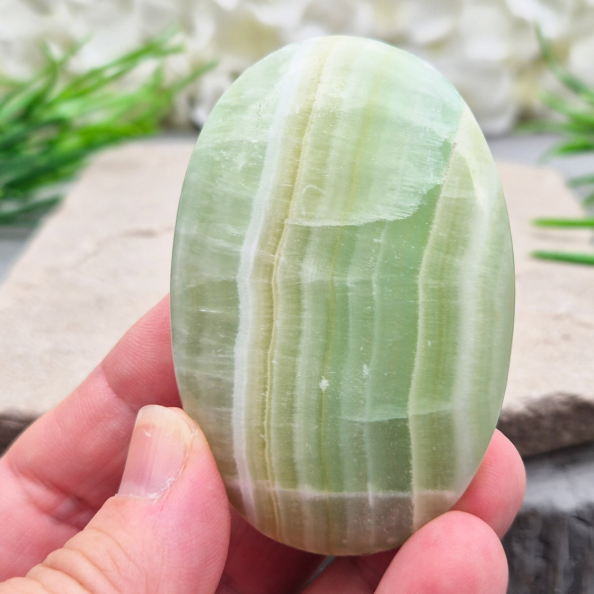 Natural Pistachio Green Calcite palm stone from Khyber Pakhtunkhwa, Pakistan. Known for calm, balance, easing stress and gentle self-compassion. 