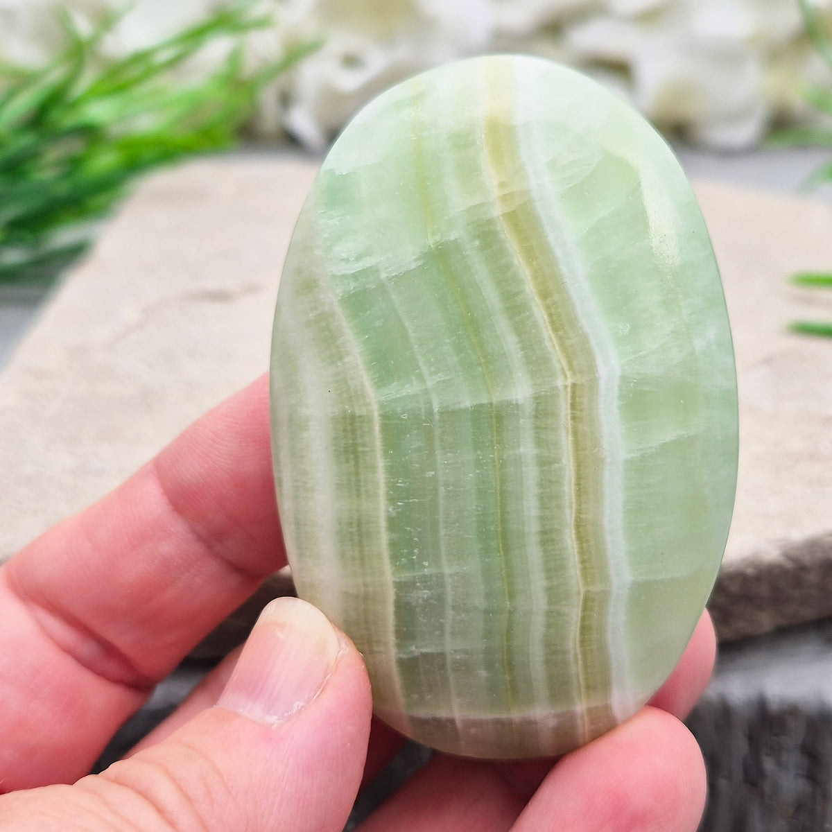 Natural Pistachio Green Calcite palm stone from Khyber Pakhtunkhwa, Pakistan. Known for calm, balance, easing stress and gentle self-compassion. 