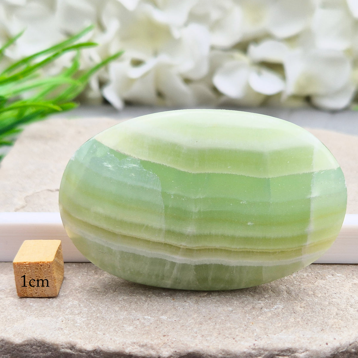 Natural Pistachio Green Calcite palm stone from Khyber Pakhtunkhwa, Pakistan. Known for calm, balance, easing stress and gentle self-compassion. 