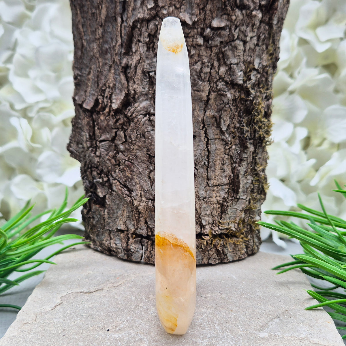 This Golden Healer Quartz teardrop is polished from Brazilian quartz, threaded through with golden inclusions of iron oxide inclusions (also known in the trade as yellow hematoid quartz). The smooth teardrop shape tapers to a clean point, standing upright on its own, with the golden banding visible right through the stone.