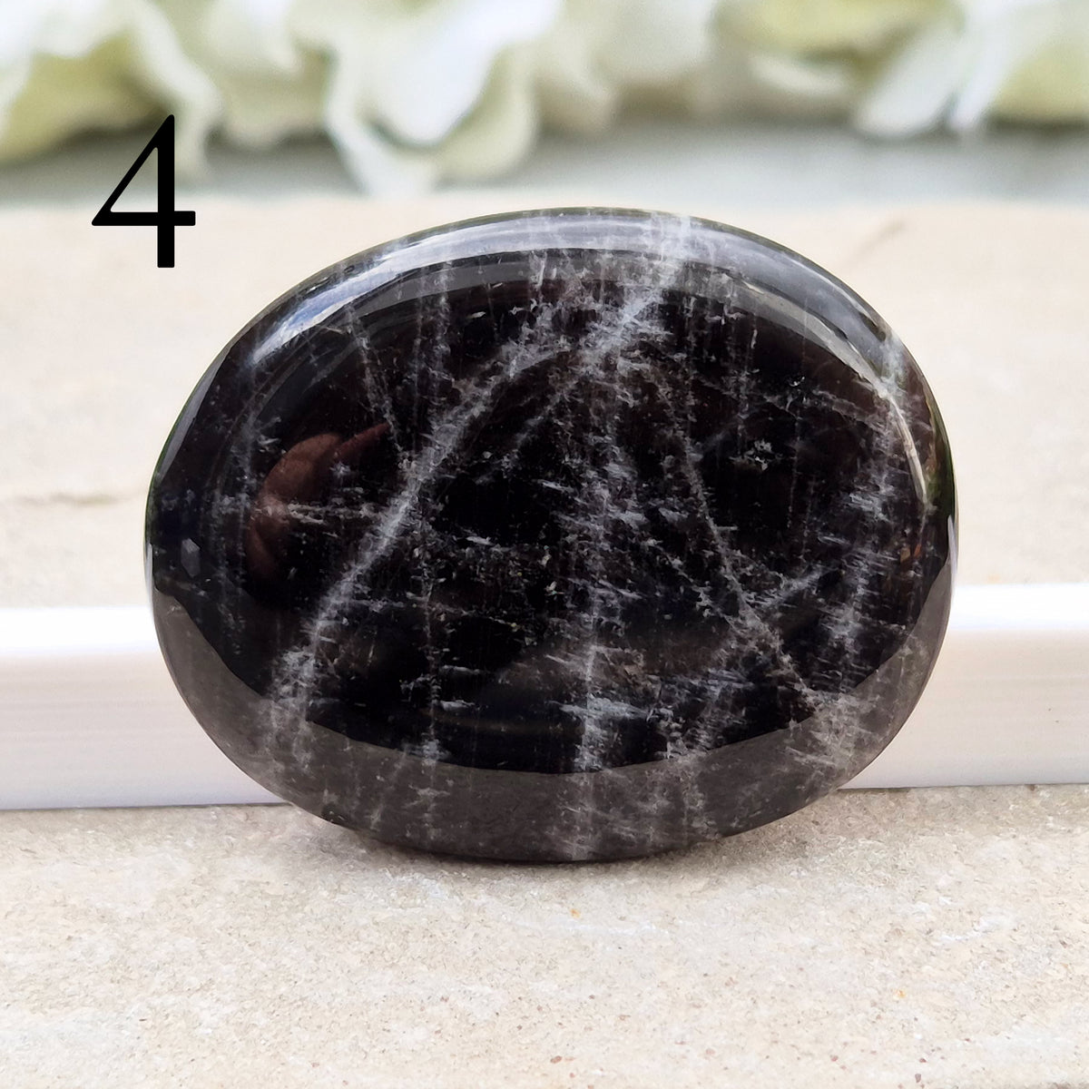 Black Moonstone Crystal Palm Stone, valued for its connection to the moon’s energy. Perfect for enhancing intuition, emotional healing, and balancing energy.