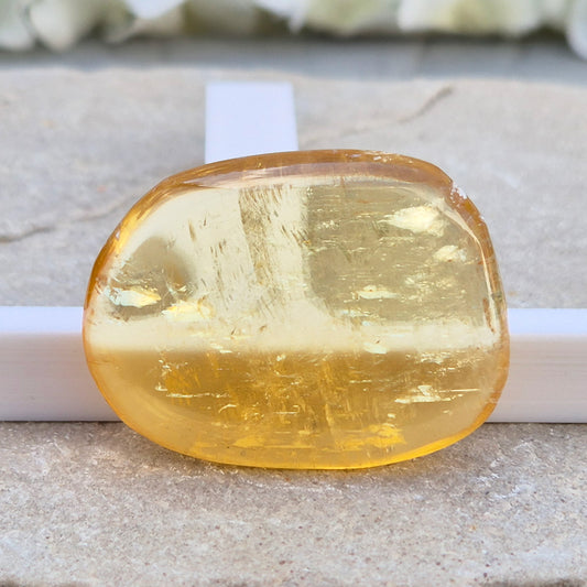 Honey Calcite Palm Stone – warm golden-amber crystal, polished for meditation & pocket carry.