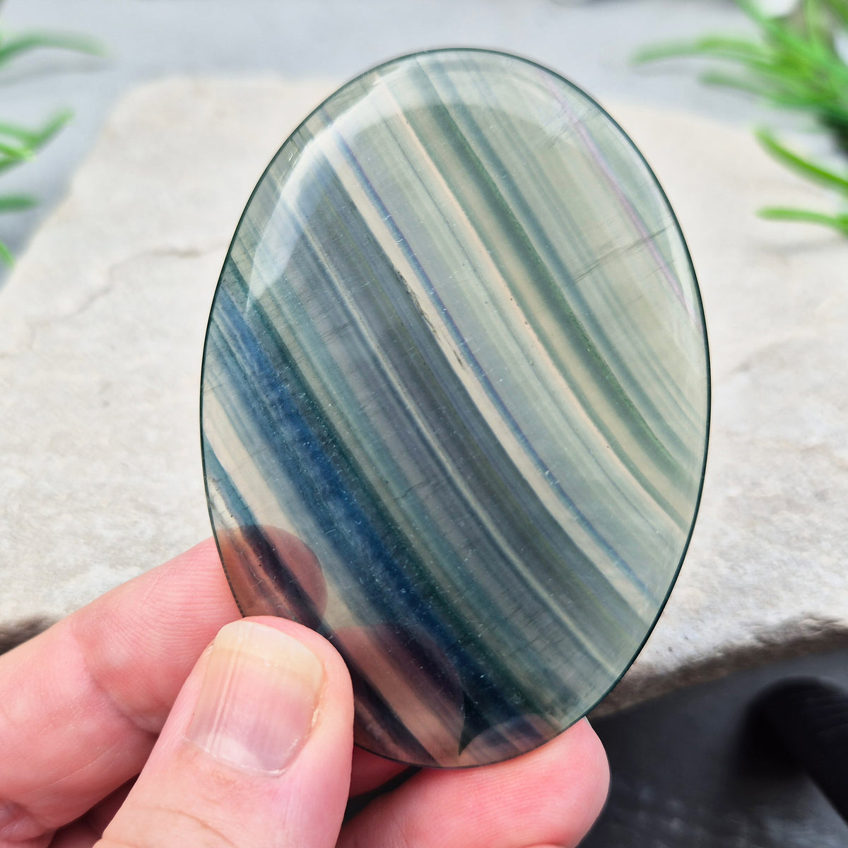 Fluorite palm stone in transparent green banding. Supports focus, mental balance, and calm energy. Perfect for holding, meditation, or gifting.