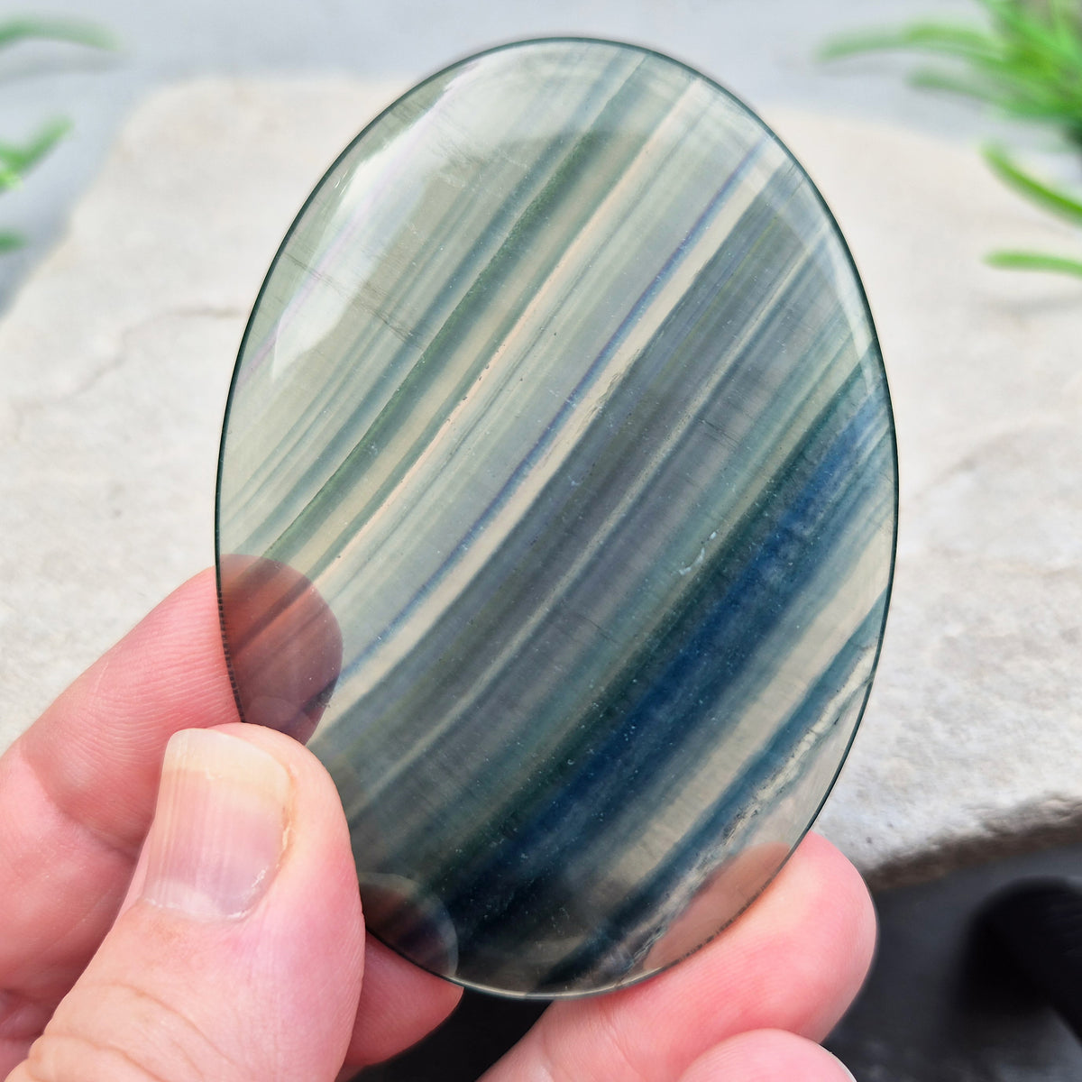 Fluorite palm stone in transparent green banding. Supports focus, mental balance, and calm energy. Perfect for holding, meditation, or gifting.