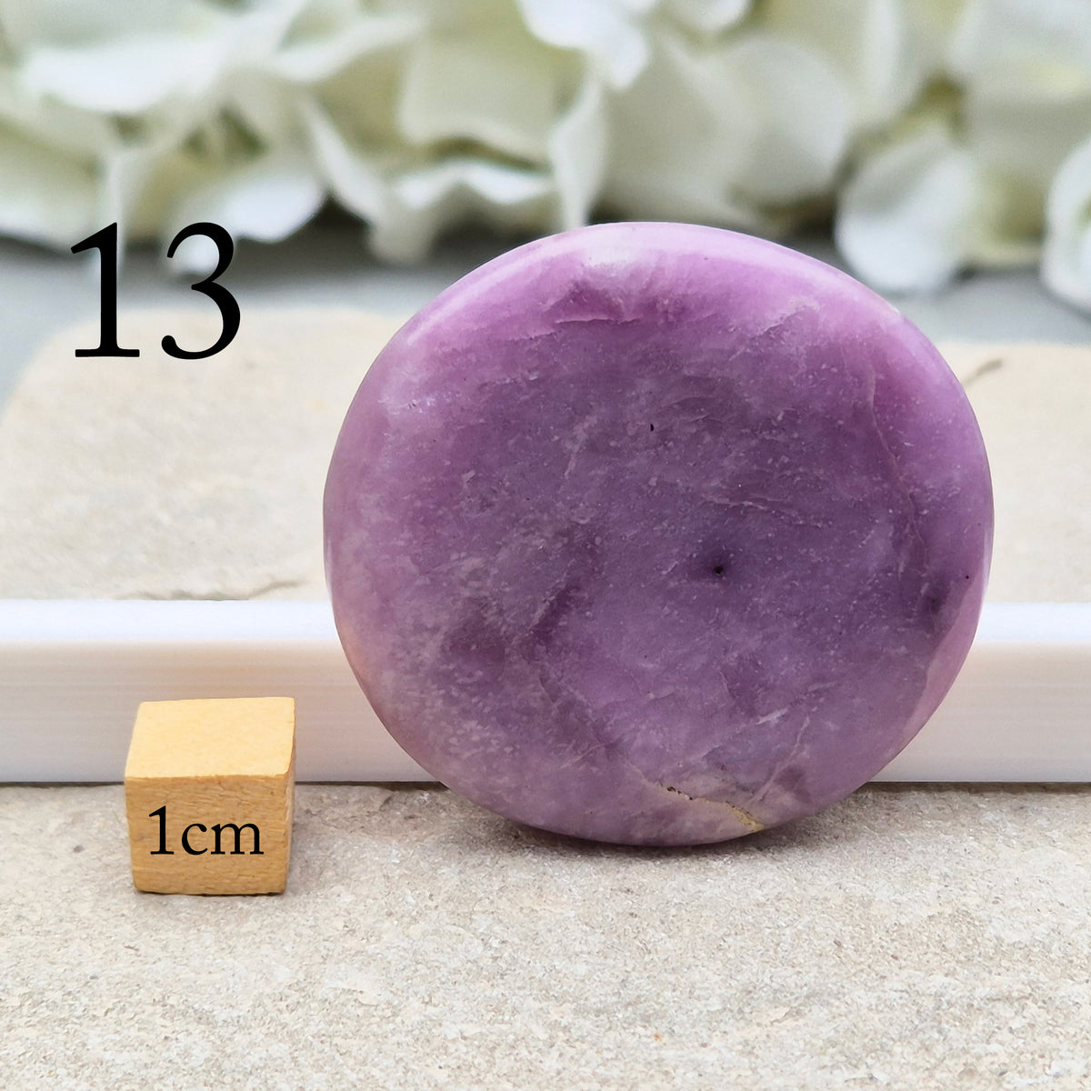 Lepidolite palm stone with calming, balancing energy. Known for easing stress and emotional overwhelm. Smooth, soothing, and ideal for daily support.